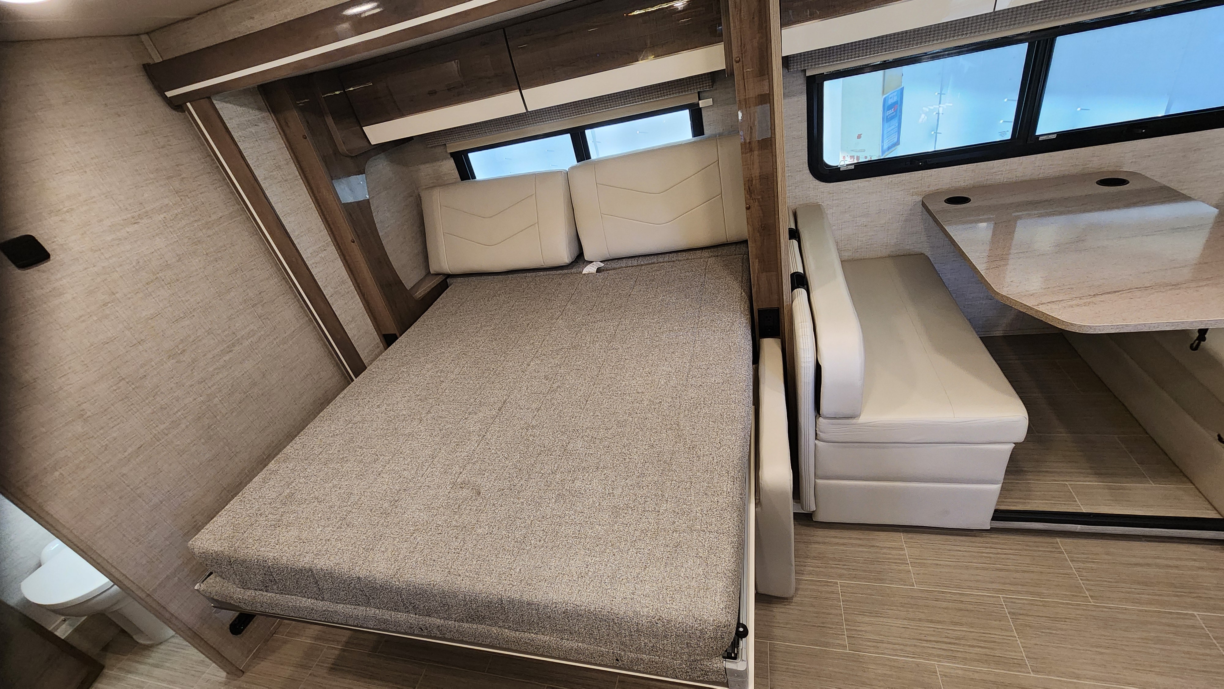 Compact RV interior with a pull-down Murphy bed and dinette, ideal for your next RV rental adventure.. Jayco Melbourne Prestige 2023