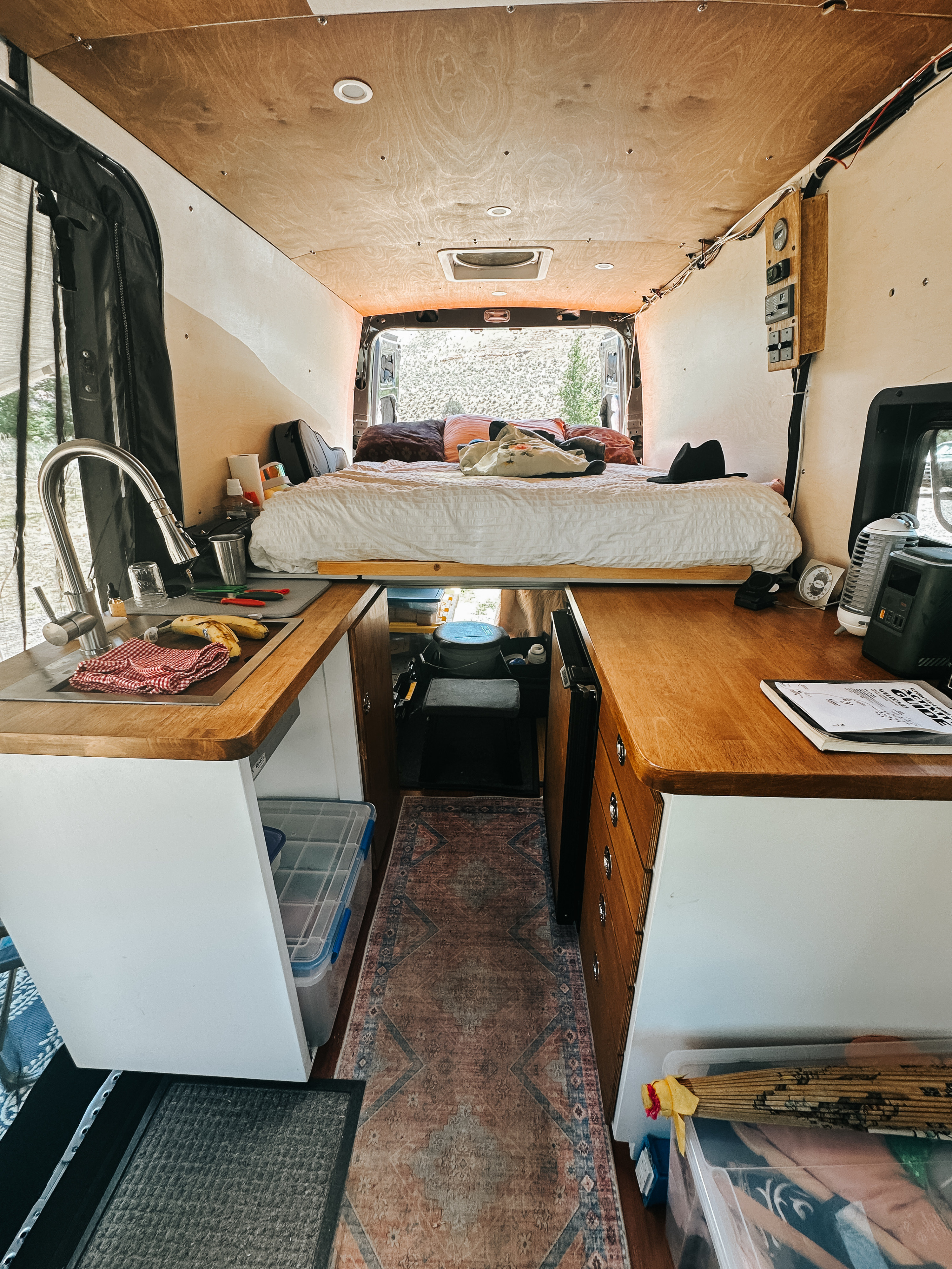 Cozy RV rental interior: fully equipped camper van with bed, kitchen, & smart storage for comfortable travel.. Mercedes-Benz Sprinter 2020