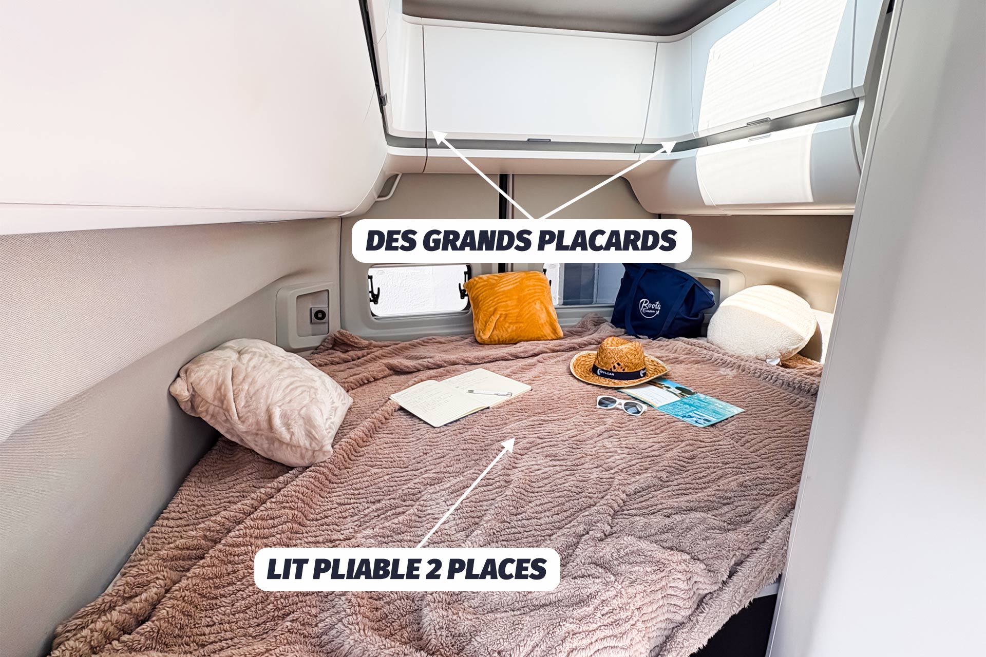 Inside an RV rental: a cozy fold-out double bed with plush blanket & large overhead storage compartments for comfortable travel.. VOLKSWAGEN Grand California 2022