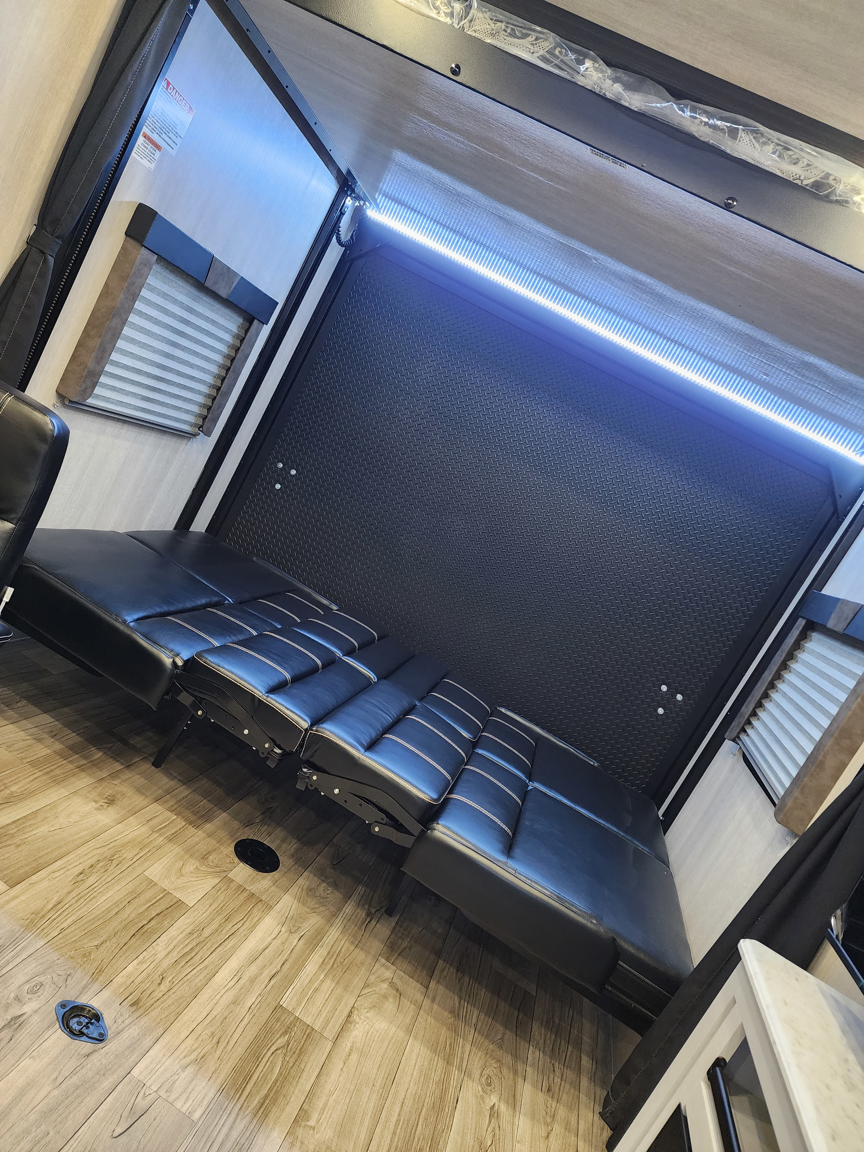 Modern RV rental toy hauler flex space with durable flooring, LED lighting, and versatile fold-down seating/beds.. Genesis Supreme Rv Genesis Supreme 2025