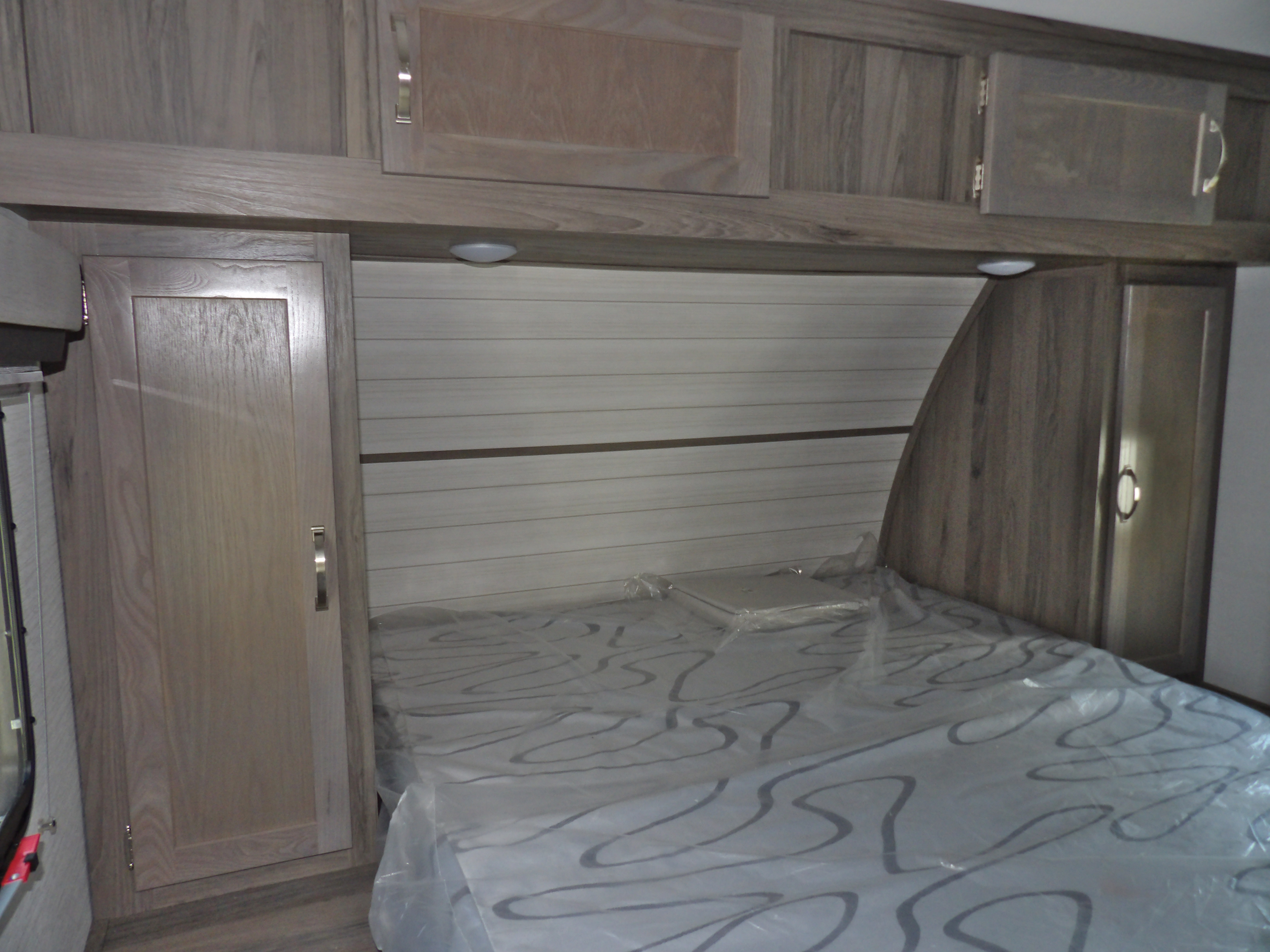 Discover comfort in this RV rental's bedroom, complete with built-in storage and a protected mattress.. Other Envision 28BBS 2025