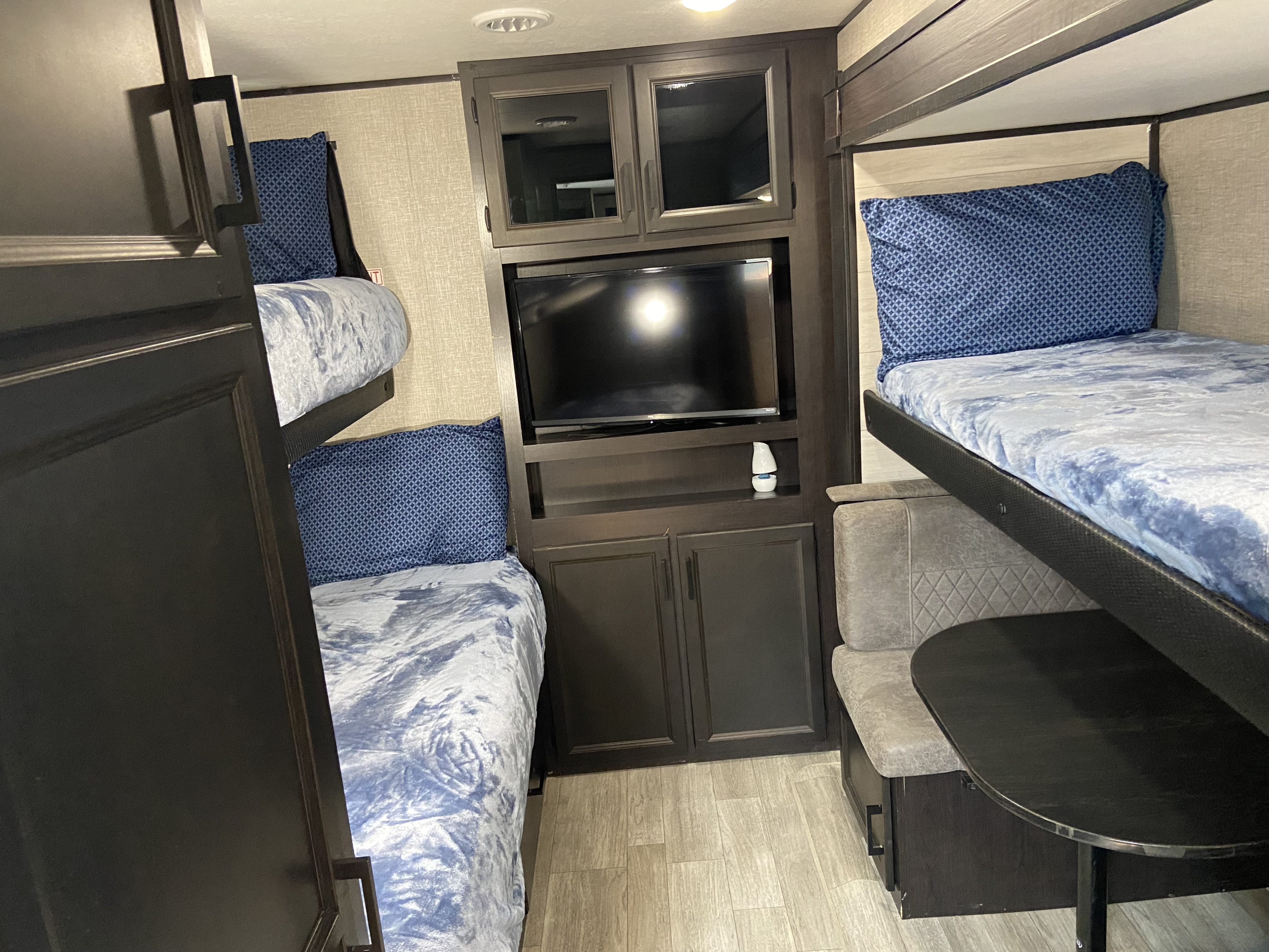 RV rental: Interior shows bunk beds, a TV, and a dinette area with table and benches. Compact and functional.. Jayco jayflight 2022