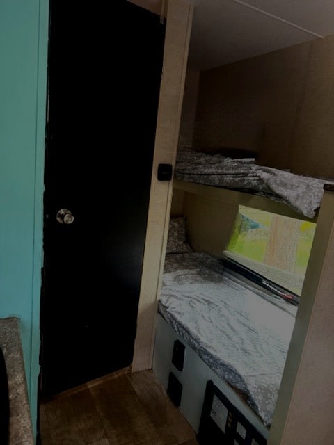 Explore this RV rental's cozy bunk bed sleeping area, complete with a window view and a private door.. KZ 4EZTK1913J4070254 2017