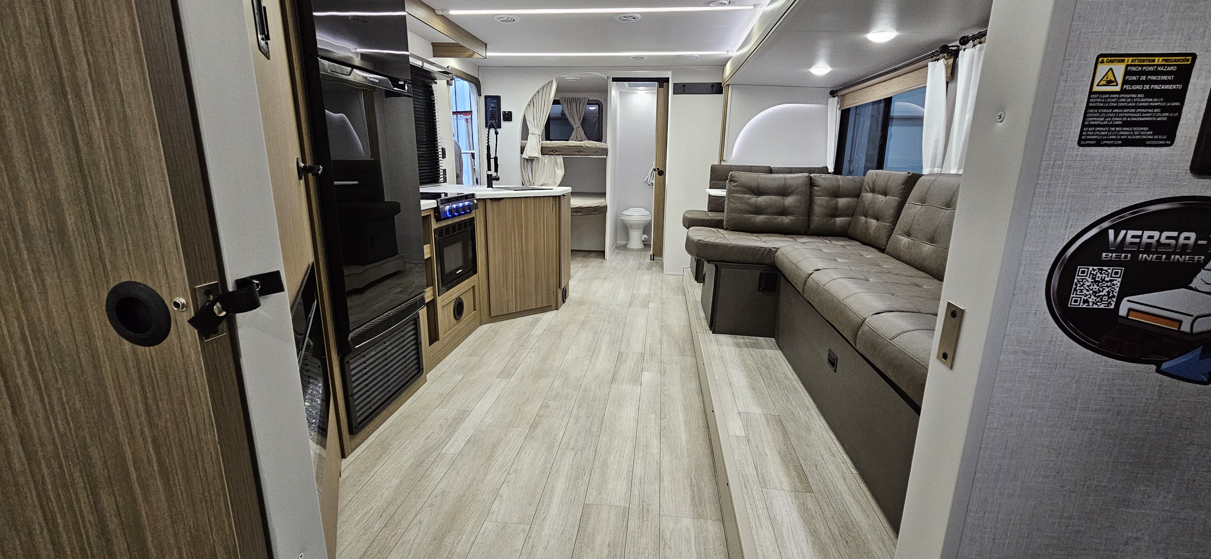 Spacious RV rental interior with a cozy lounge, modern kitchen, bathroom, and bunk beds for comfortable travel.. Forest River-Salem Cruise Lite 26ICE 2025