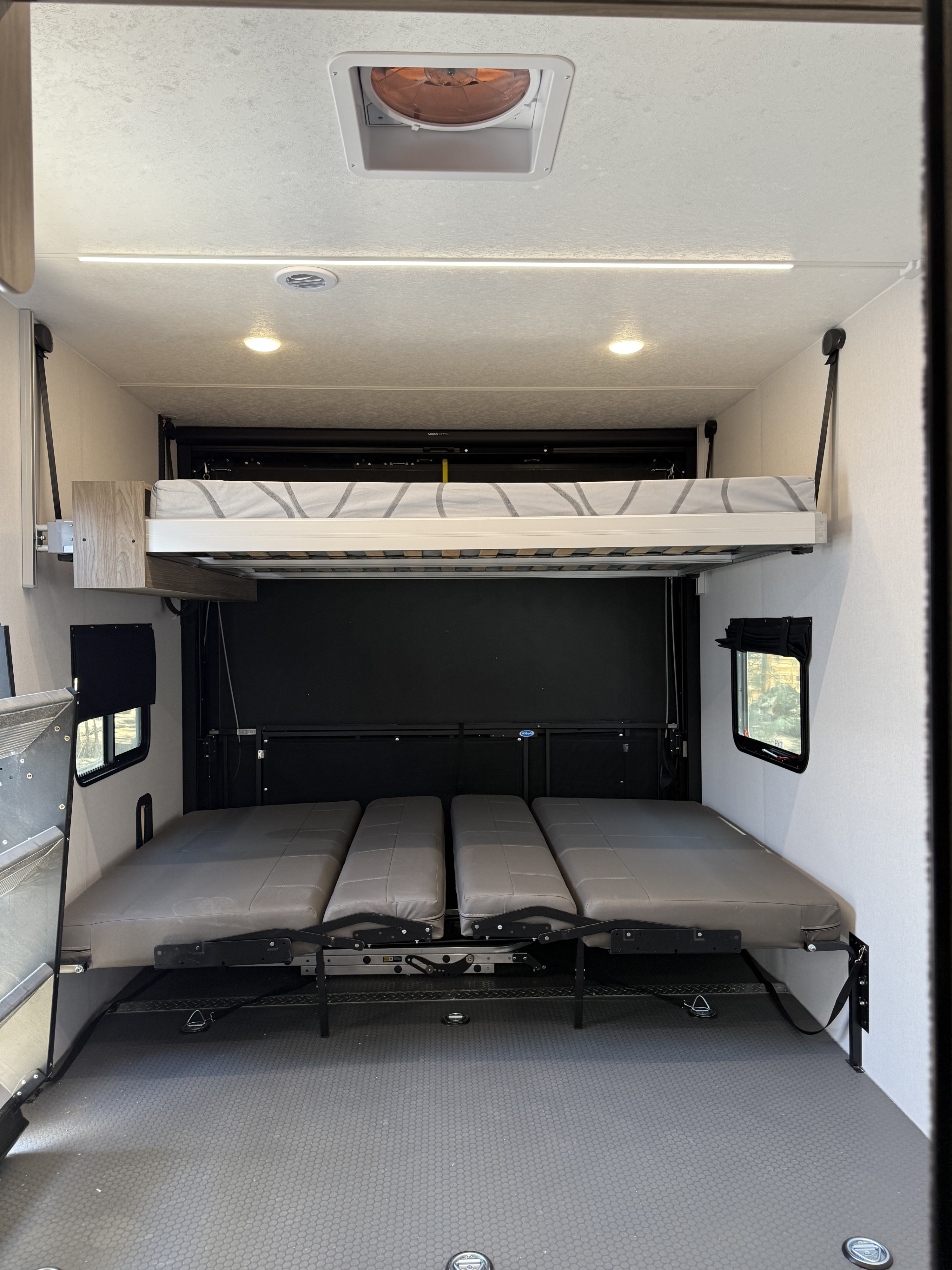 RV rental: Bright, versatile RV interior showcasing adjustable bunk beds and lower convertible seating for flexible use.. Coachmen Adrenaline 2025