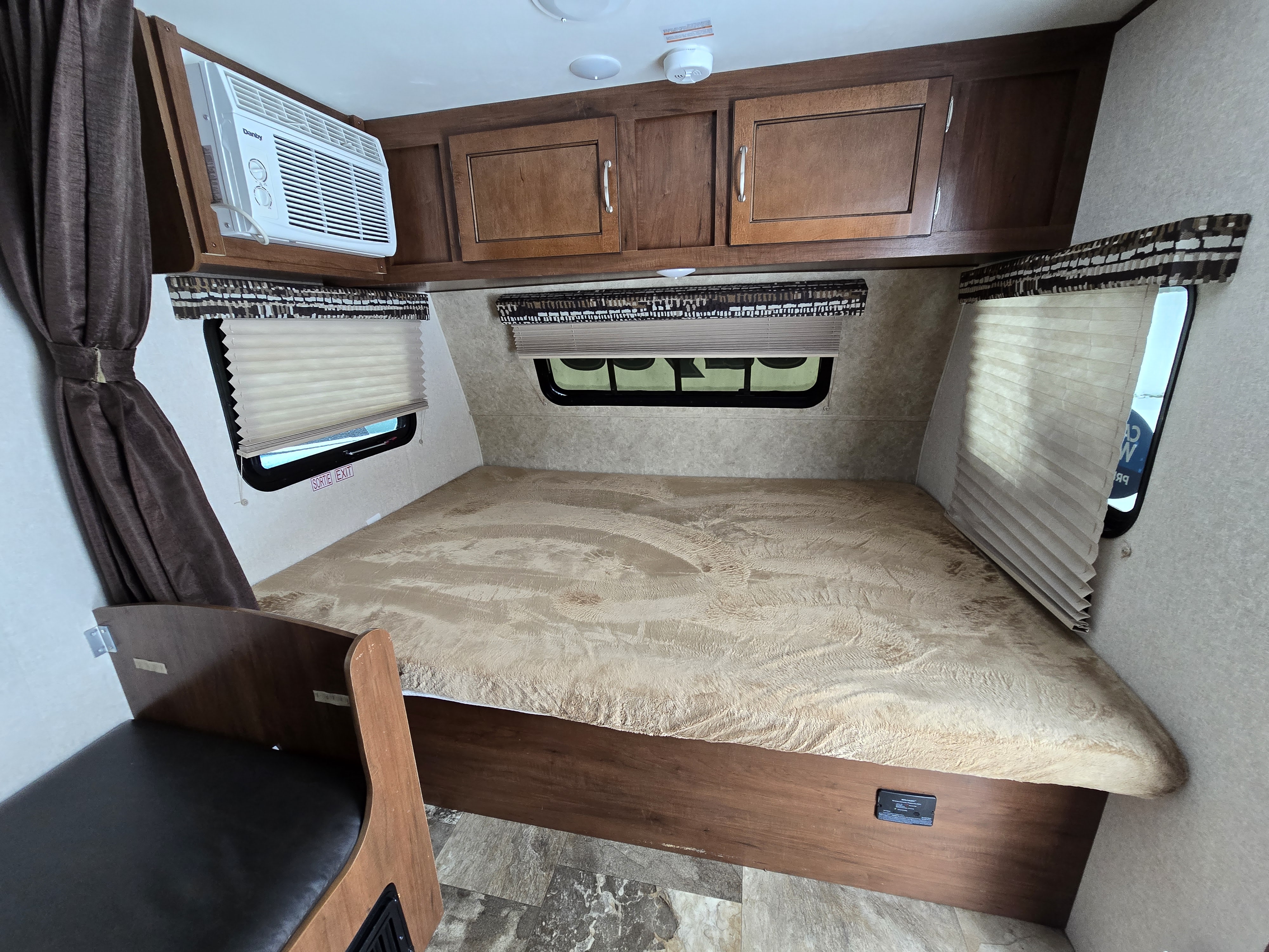 Cozy RV rental interior with a comfortable bed, AC, and storage. Perfect for your travel adventures or camping trip.. Jayco Jay Flight SLX 2017