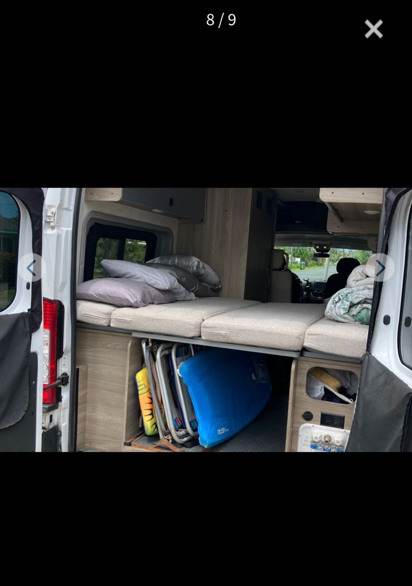 RV rental interior: comfy bed, clever under-bed storage for gear like chairs and boards, plus power outlets. Ready for travel.. Dodge Ram Van Roadtrek 2019