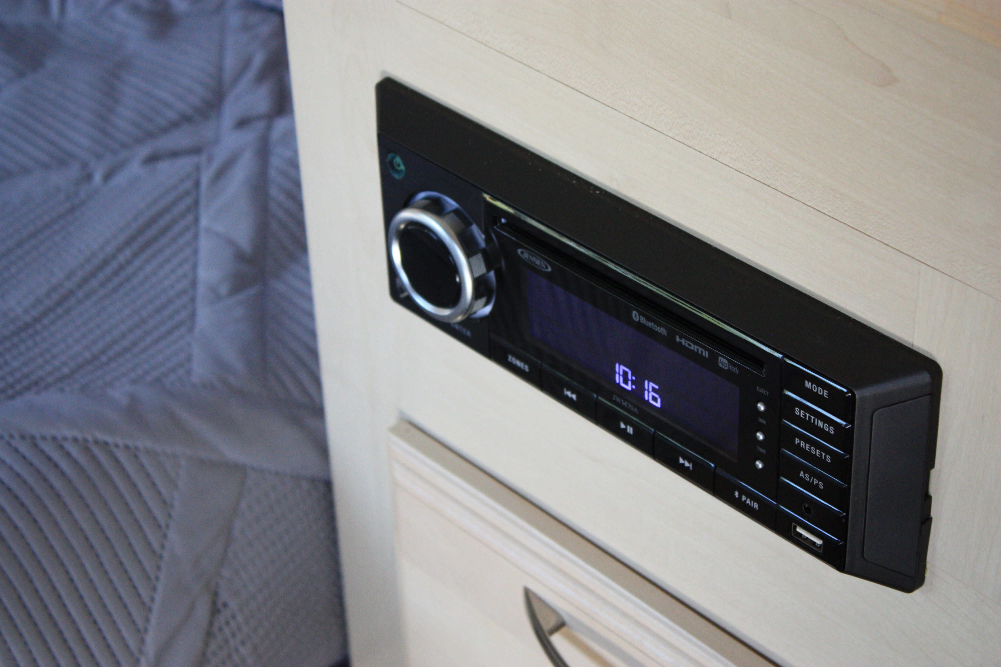 RV rental: Close-up of a JENSEN JWM70A stereo unit, displaying 10:16, with Bluetooth and HDMI connectivity.. Winnie Drop Winnie Drop Trailer 2018