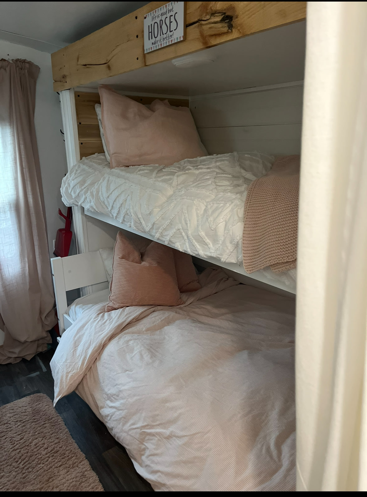 Stylish bunk beds with pink & white bedding in a compact RV rental. Ideal for a cozy family stay or travel adventures.. Jayco Jay Feather Ultra Lite 2019