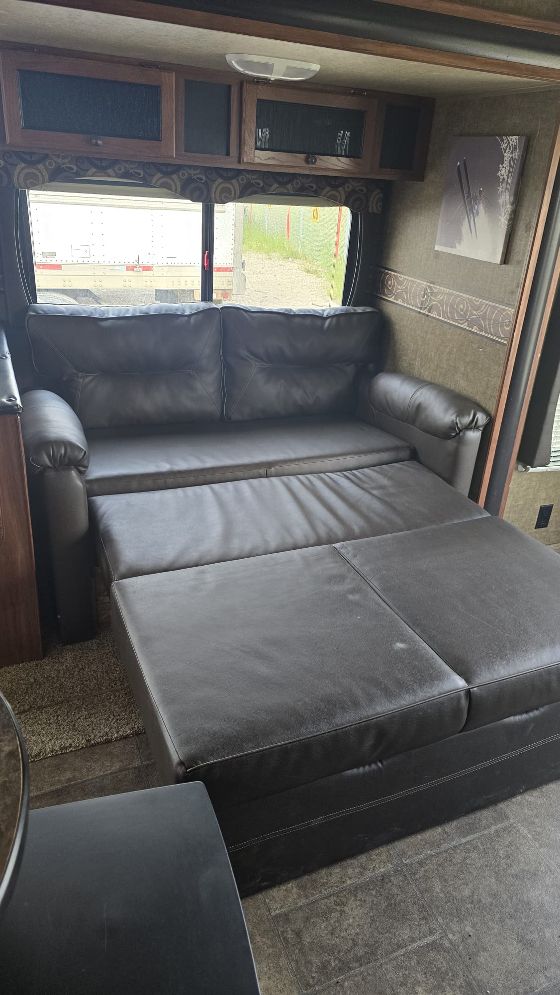 Spacious RV rental interior featuring a versatile pull-out sofa bed. Ideal for comfortable travel.. Heartland RVs Trail Runner 2015