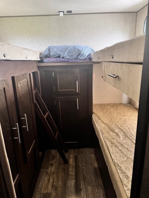 RV rental bunk beds and storage. Interior view of a practical sleeping area with a ladder.. Forest River Cherokee Grey Wolf 2016