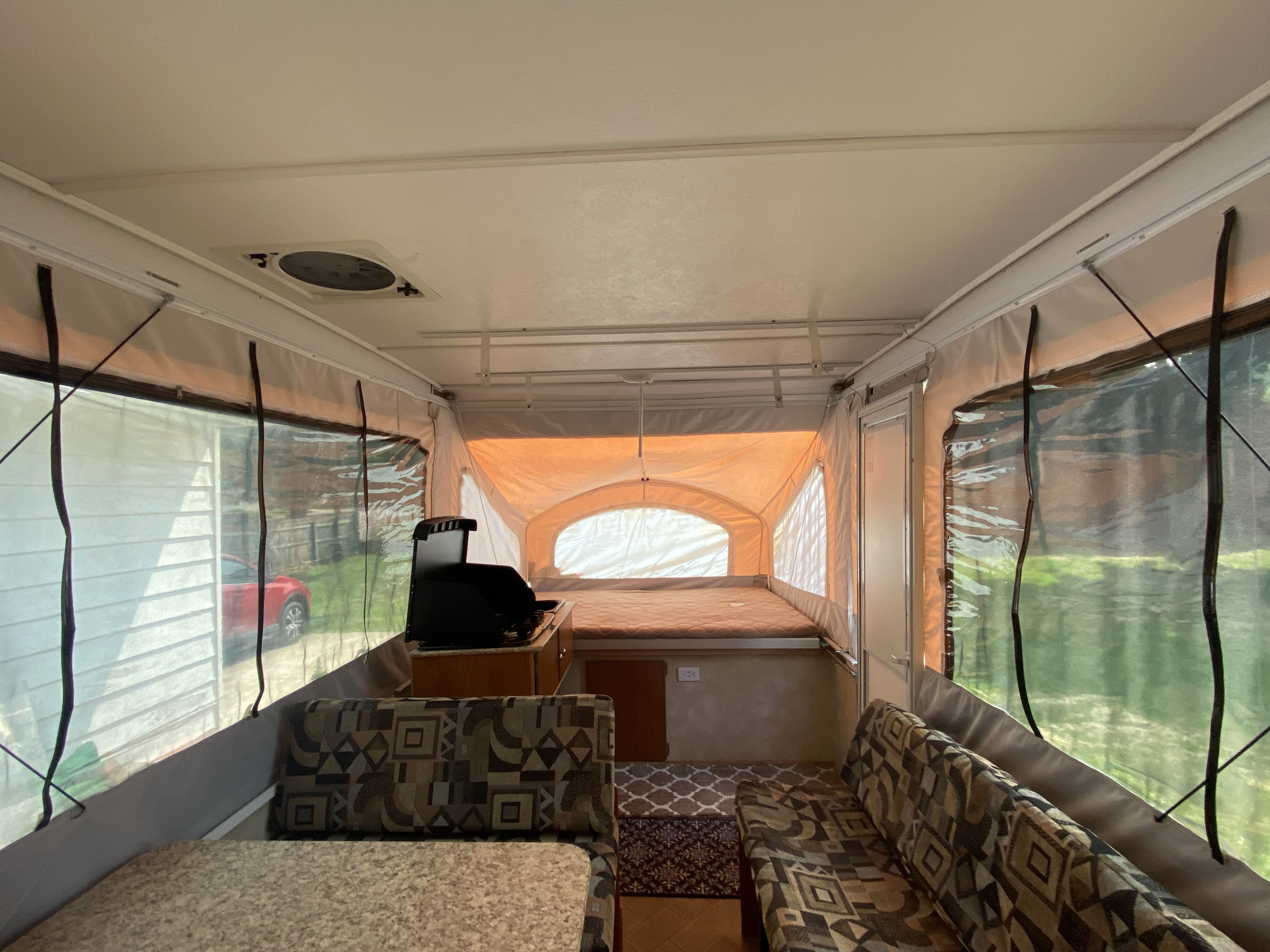 Step inside this RV rental: a spacious pop-up camper with beds, a kitchen unit, and comfortable seating areas.. Coachmen Clipper Sport 108ST 2012