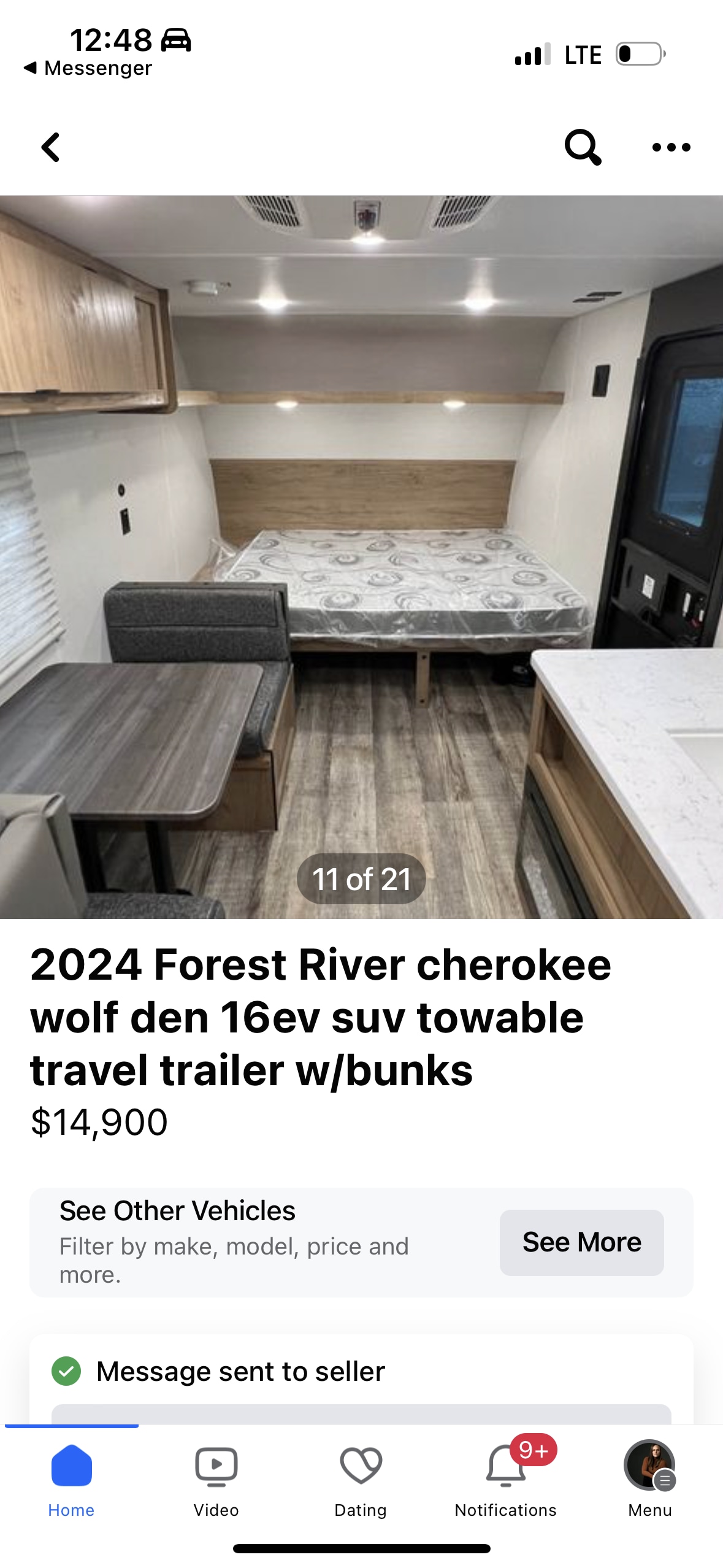 Interior of a new 2024 Forest River travel trailer for sale, featuring a bed, dinette, and kitchen. Great for RV rental!. Forest River Wolf Den 2024
