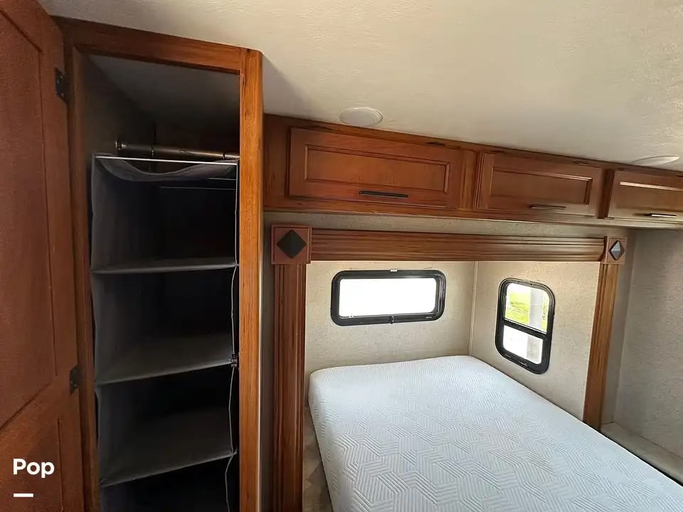 RV rental bedroom with a comfy bed, overhead storage cabinets, and a convenient hanging closet. Ready for your travels!. Jayco Melbourne 2016
