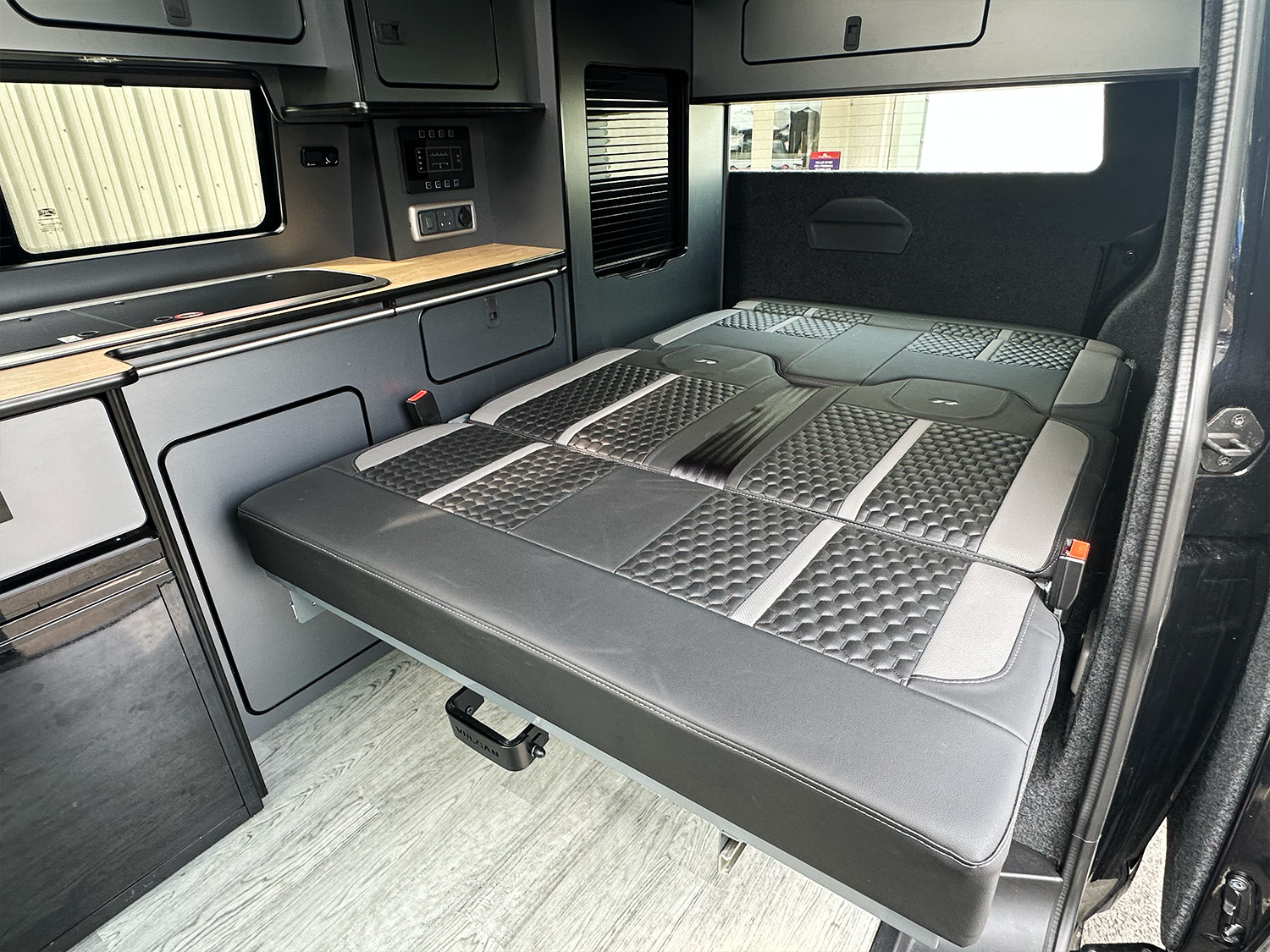 Step inside this rv rental's camper van interior, featuring a versatile pull-out bed, compact kitchen, and integrated controls.. Volkswagen T6.1 Transporter 2024