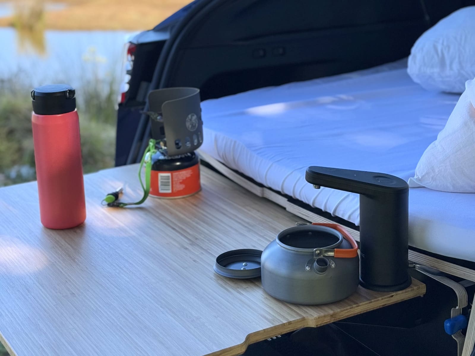 Rv rental: mobile camping setup with stove, kettle, water dispenser, and a comfy van bed.. Telstar Model Y 2023