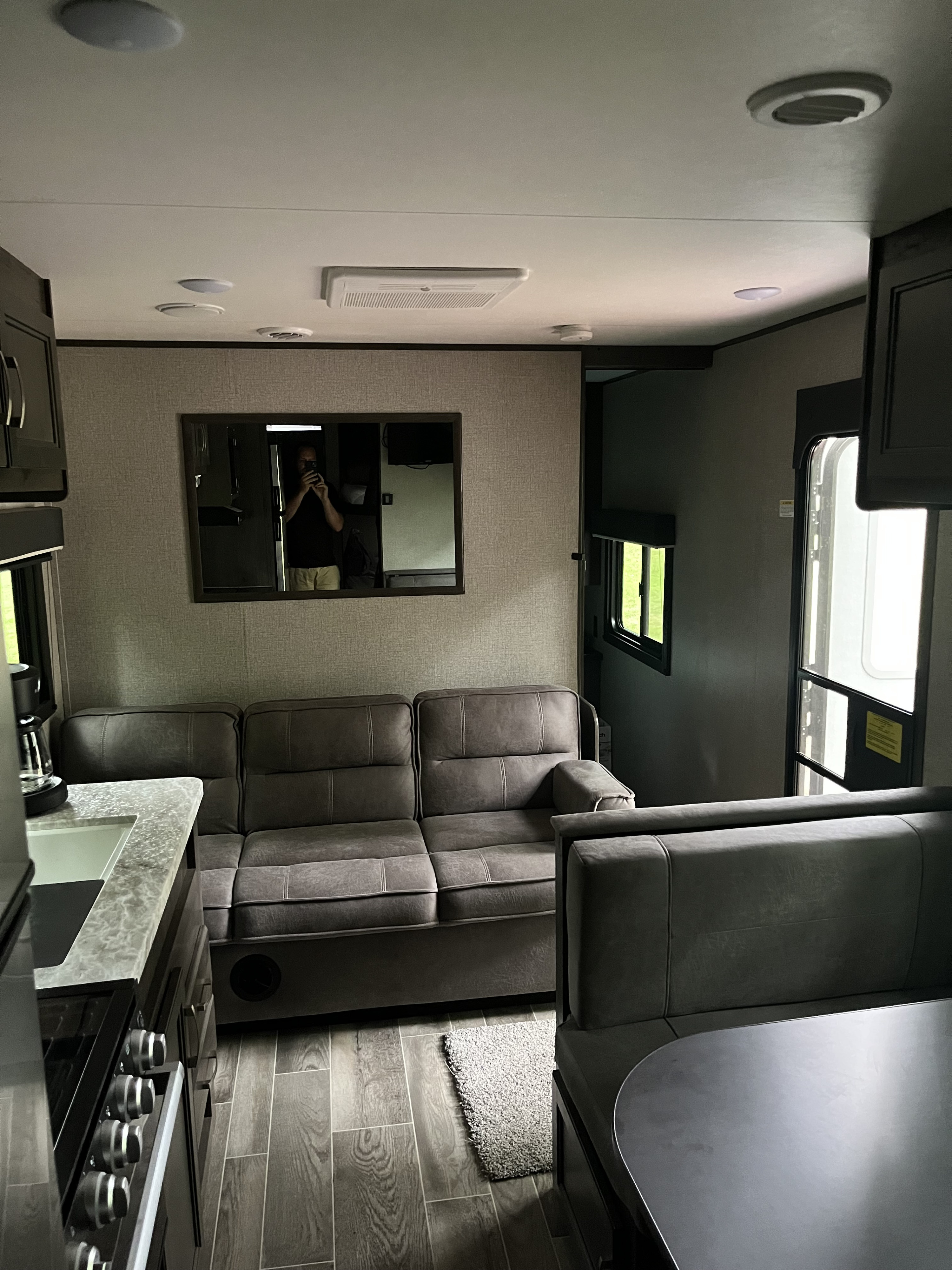 Experience comfortable travel in this modern rv rental. It features a cozy living area, dining space, and compact kitchen.. Jayco Jay Flight SLX 2021