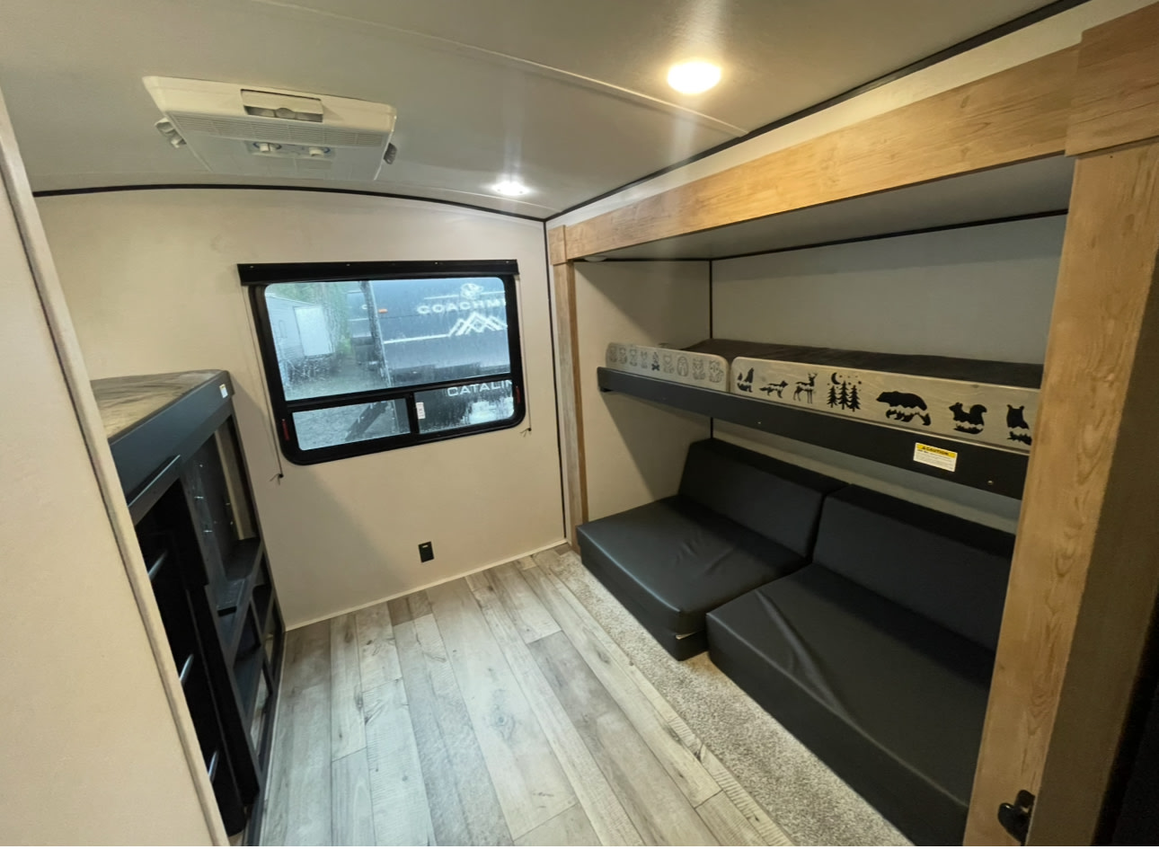 Spacious RV rental interior with bunk beds, convertible seating, and bright living area. Ideal for family trips.. Keystone RV Springdale 2022