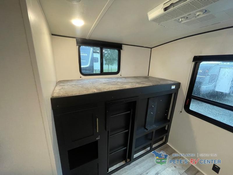 RV rental interior: Built-in bunk bed with storage, two windows, and an overhead AC unit for comfortable travel.. Keystone RV Springdale 2022