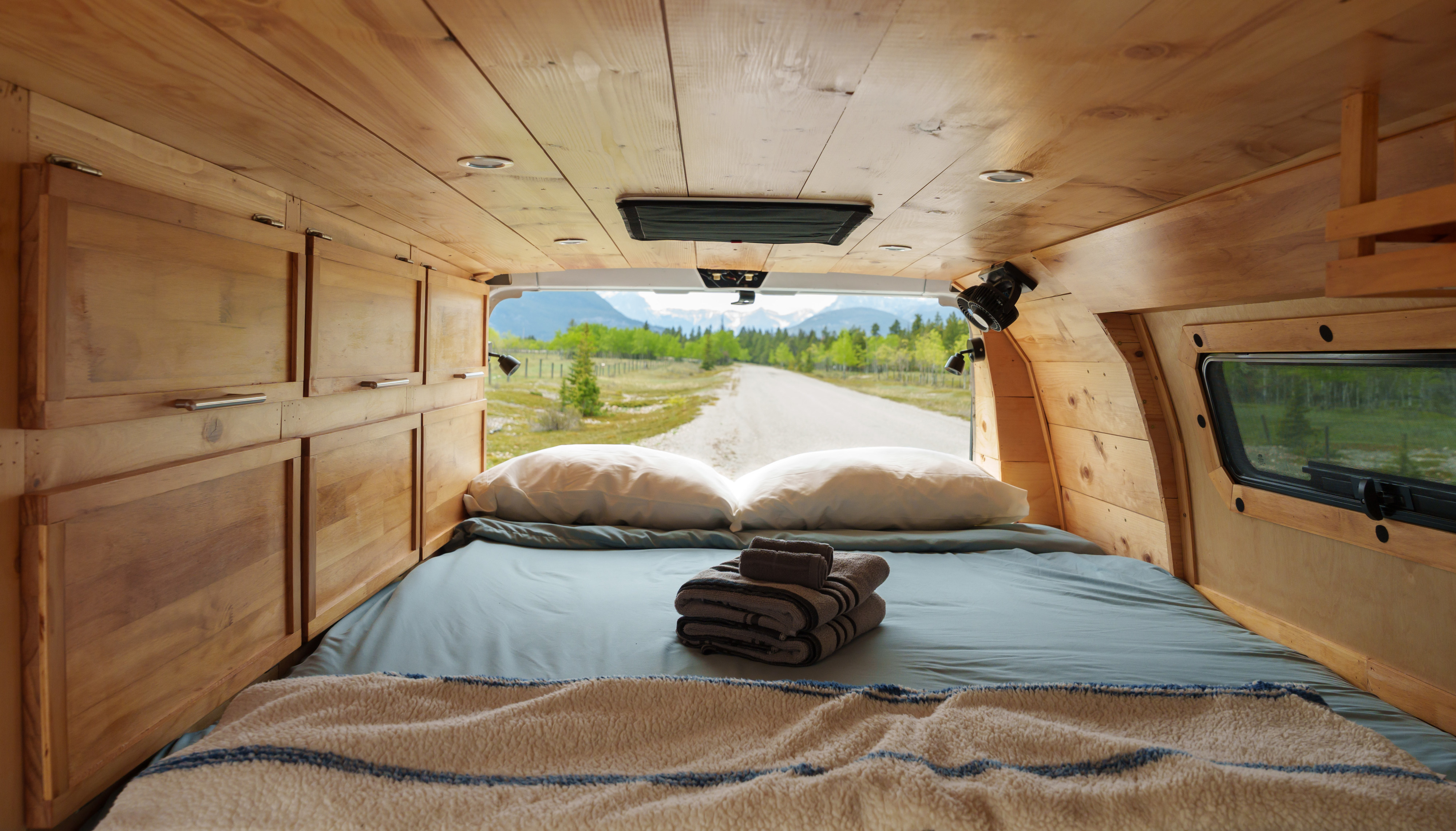 Cozy RV rental interior with a mountain road view, perfect for your next adventure.. Ford Econolline 250s 2011