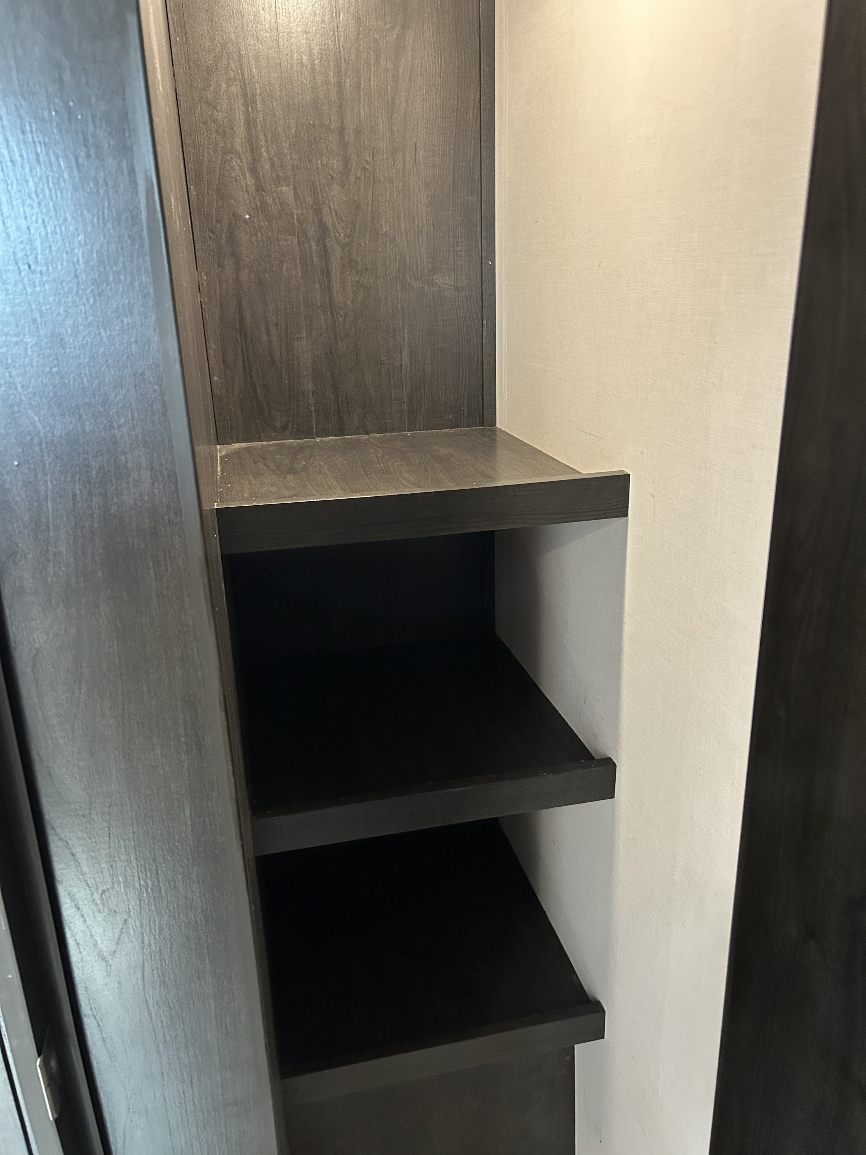 RV rental: This RV features dark wood built-in shelving, providing ample interior storage for your travel essentials.. Forest River Surveyor Legend 2020