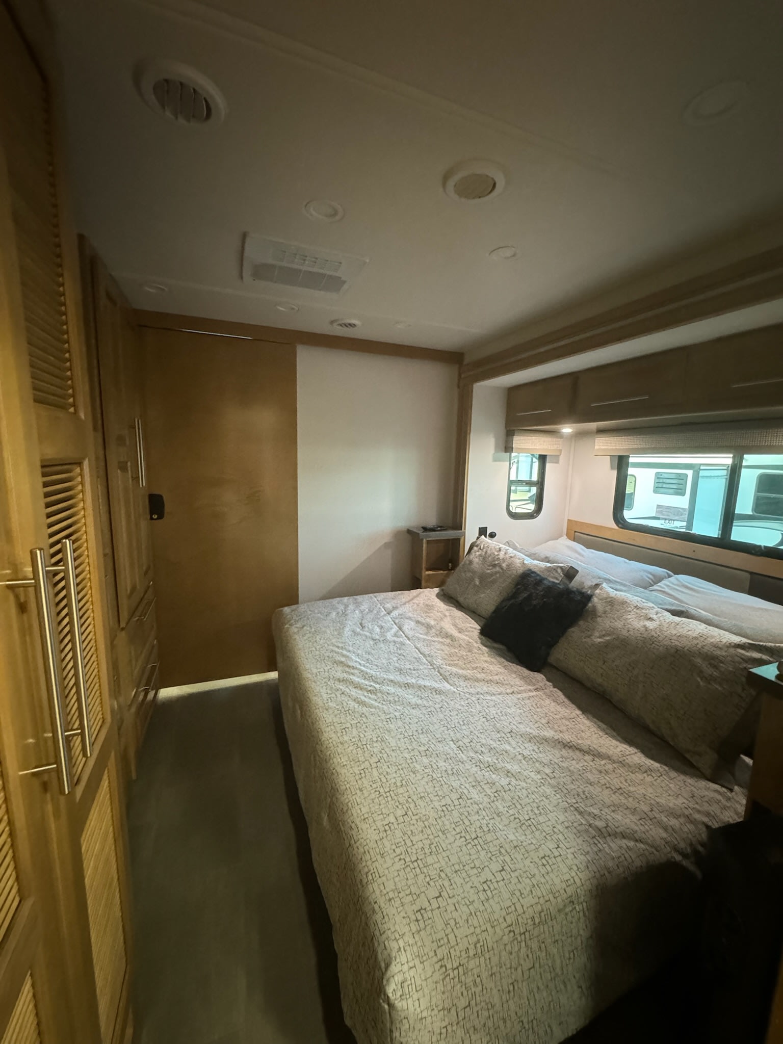 RV rental bedroom features a comfortable bed, ample storage, and windows, designed for your travel comfort.. Georgetown GT7 2024