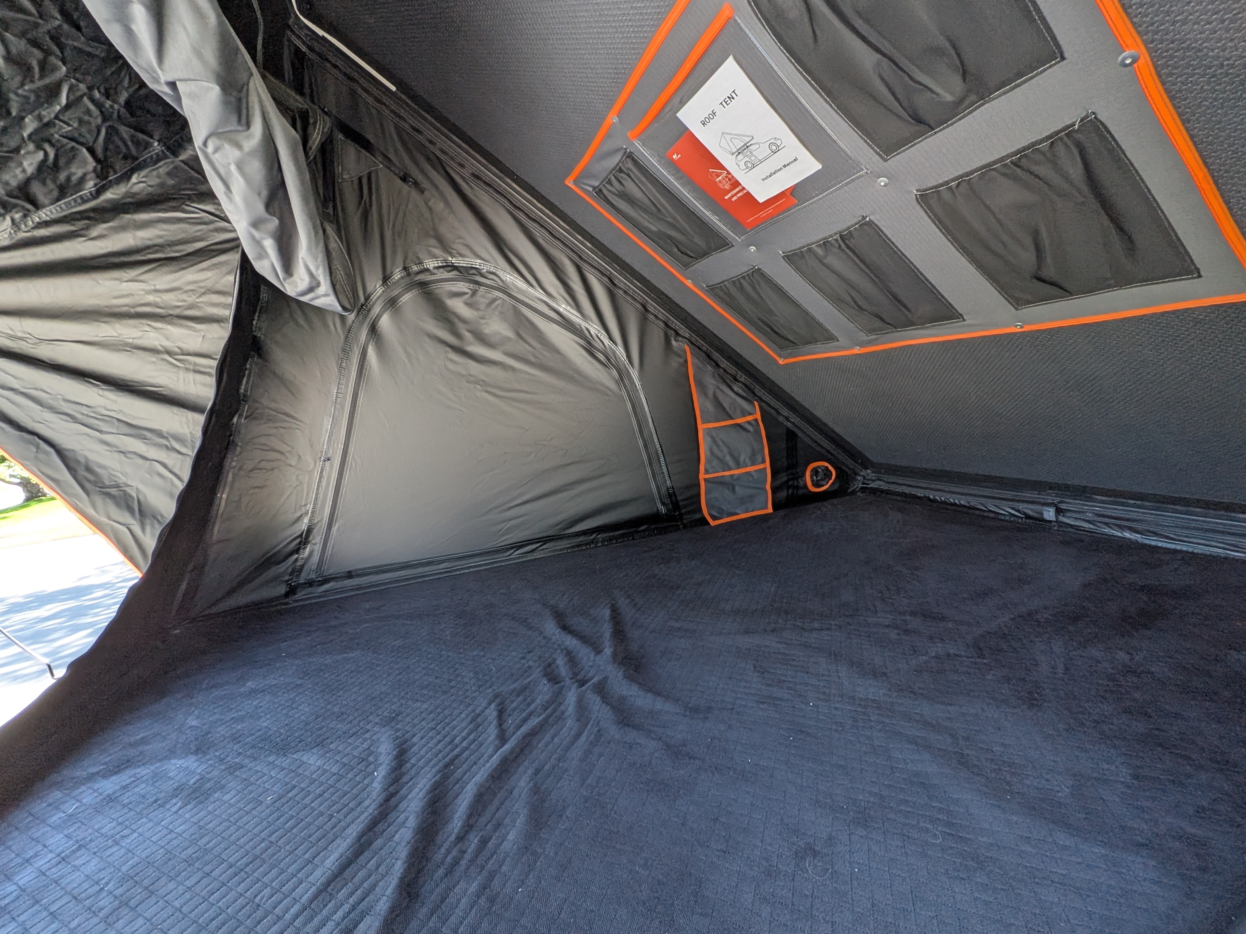 Roof tent interior for RV rental adventures: comfy mattress, overhead storage with manual, and side pockets.. Toyota Sienna 2012
