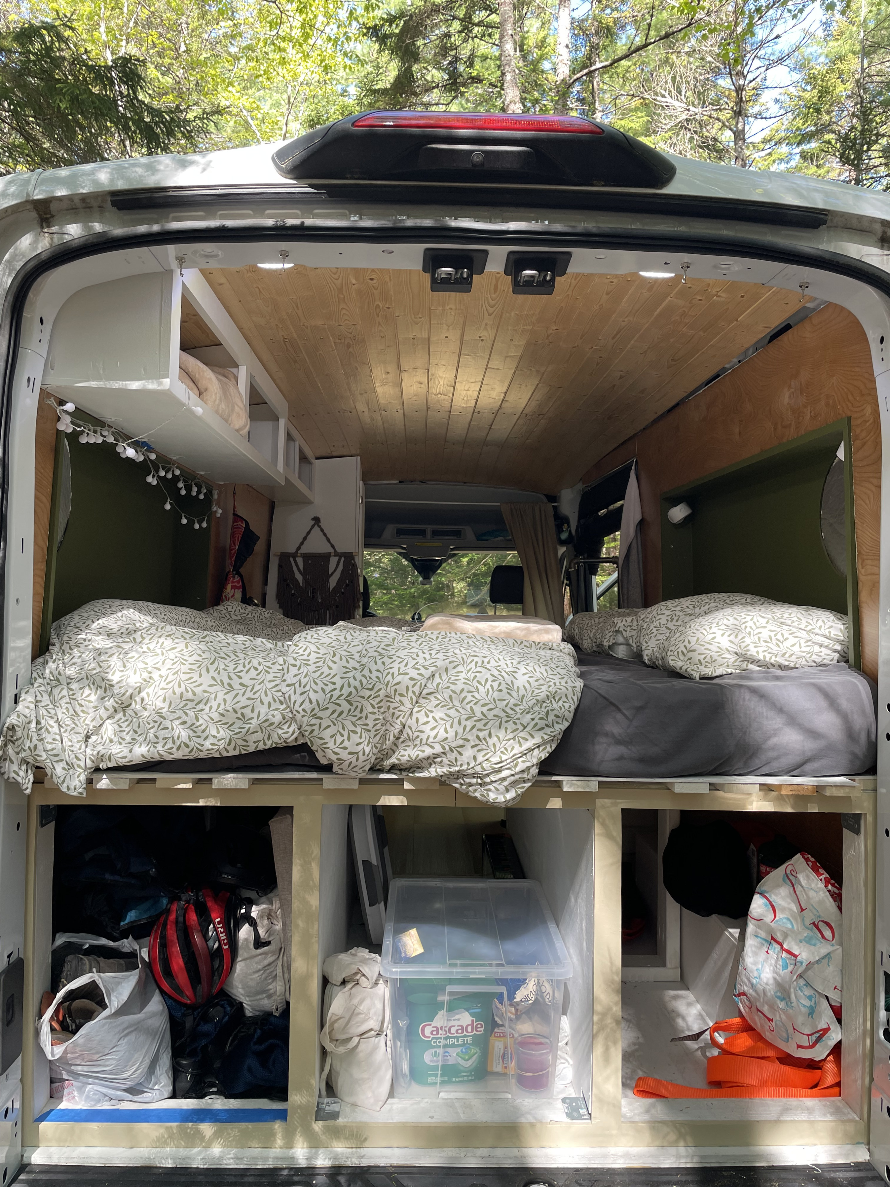 RV rental interior view: two beds, overhead shelves, and under-bed storage for mobile adventures.. Ford transit 2020