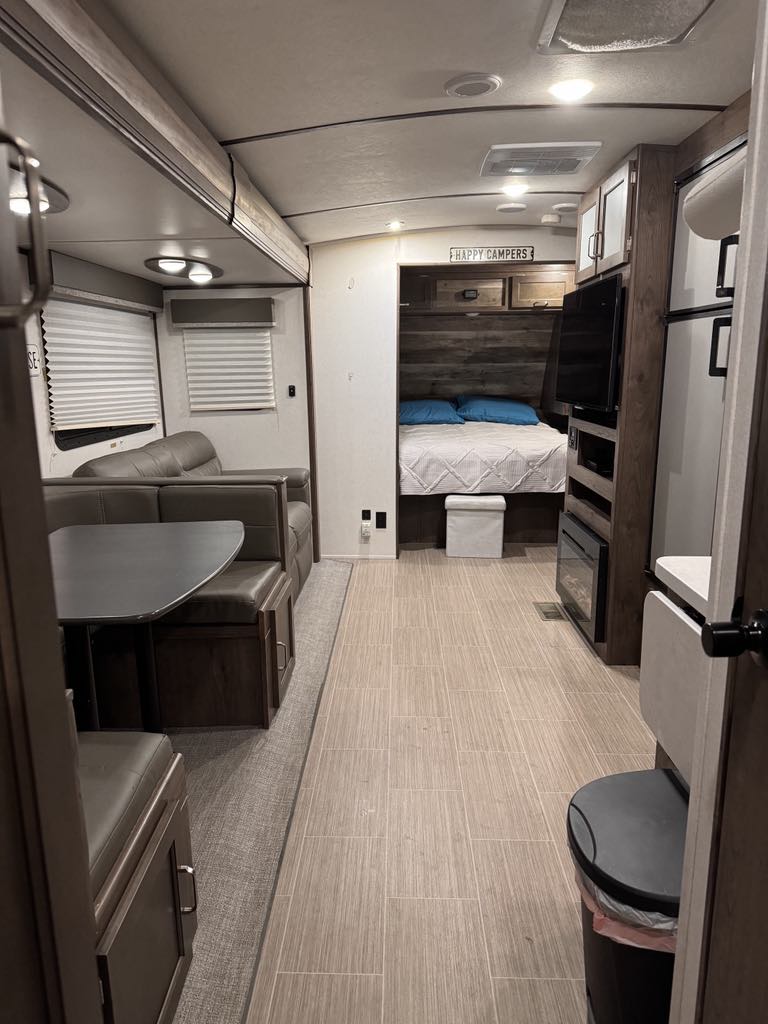 Spacious rv rental interior with modern kitchen, cozy dining, and comfy bed. Perfect for happy campers.. Keystone RV 3400QD 2020