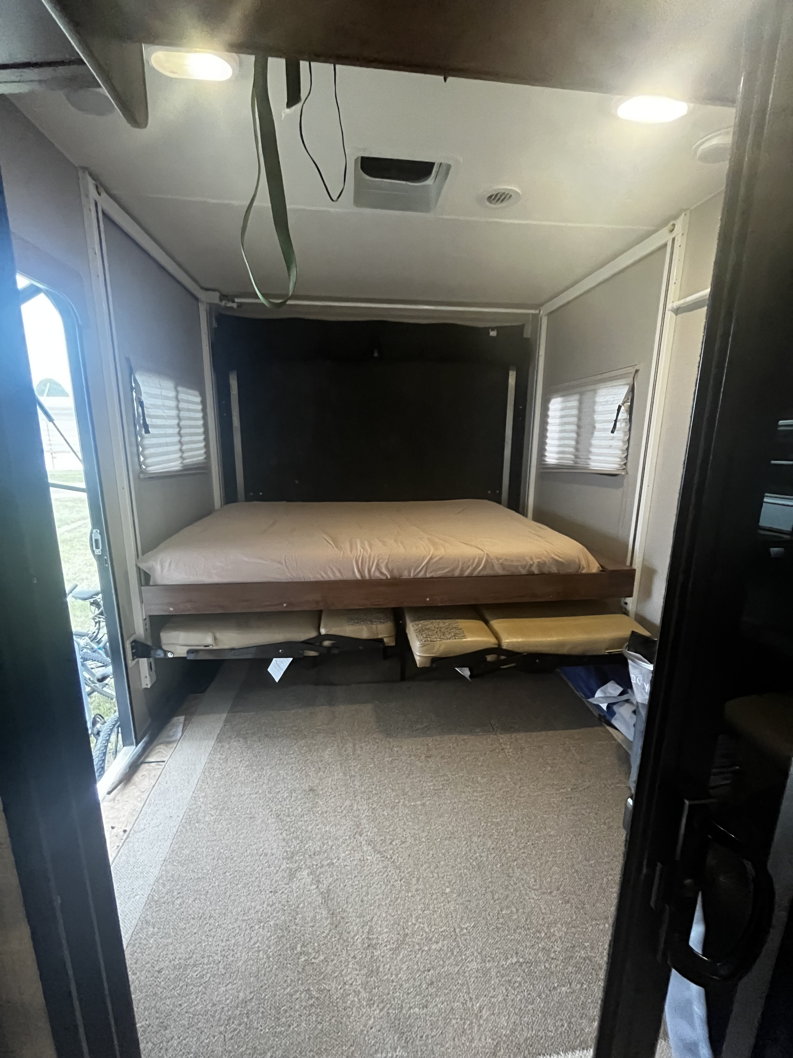 Inside this RV rental: a modular bed system with an upper bunk and lower cushions, offering flexible sleeping/lounge space.. Coachmen Freedom Express 2017