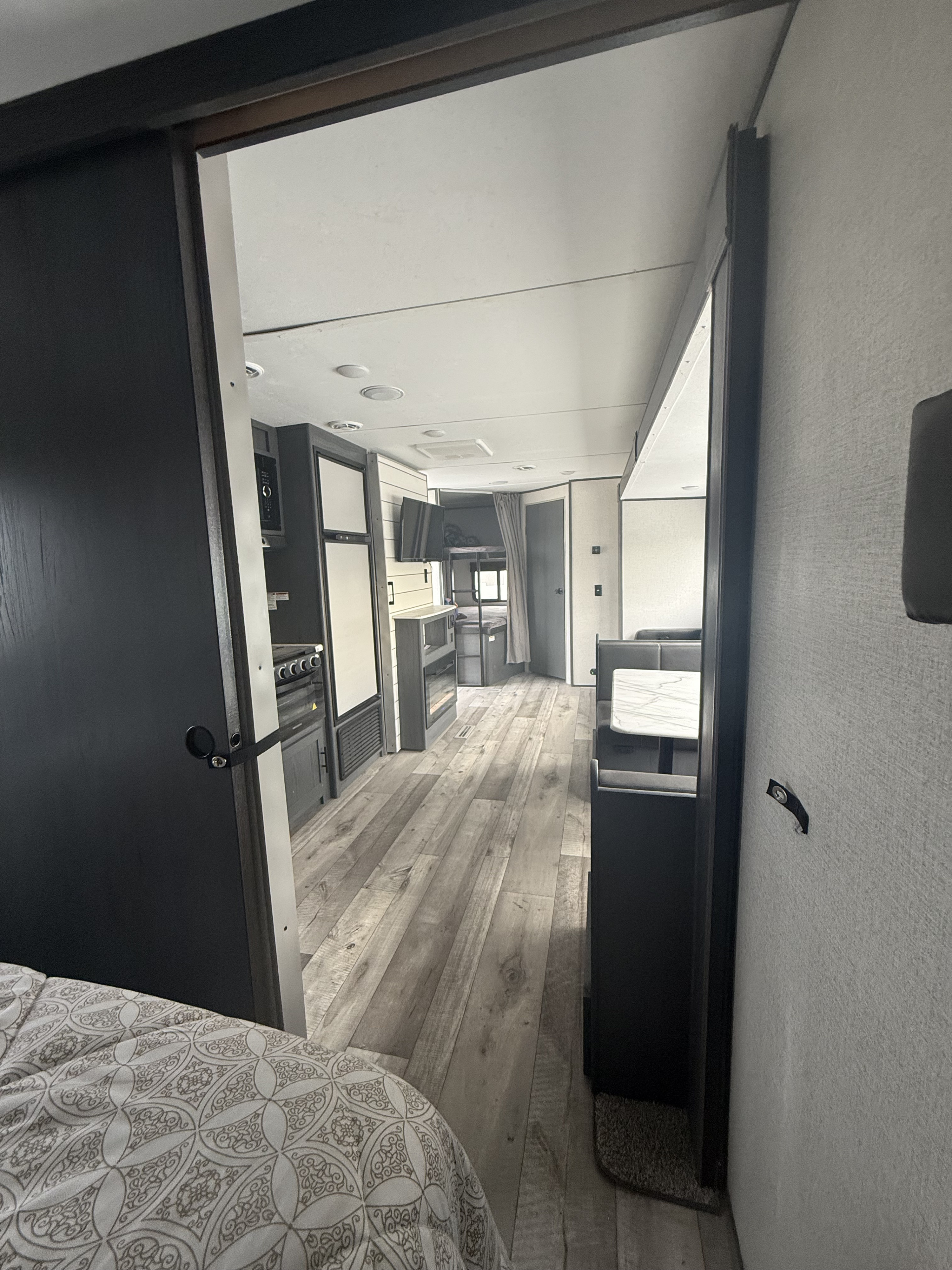 Step inside this RV rental! Features a modern kitchen, comfortable dinette, and cozy rear bunk beds for travel.. Aspen Trail Aspen Trail Trailer 2021