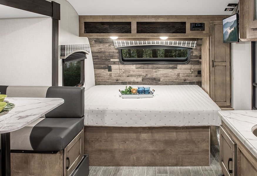 RV rental: Spacious interior boasts a comfortable bed, dinette, kitchen, and rustic wood paneling.. Sonic Lite 2023