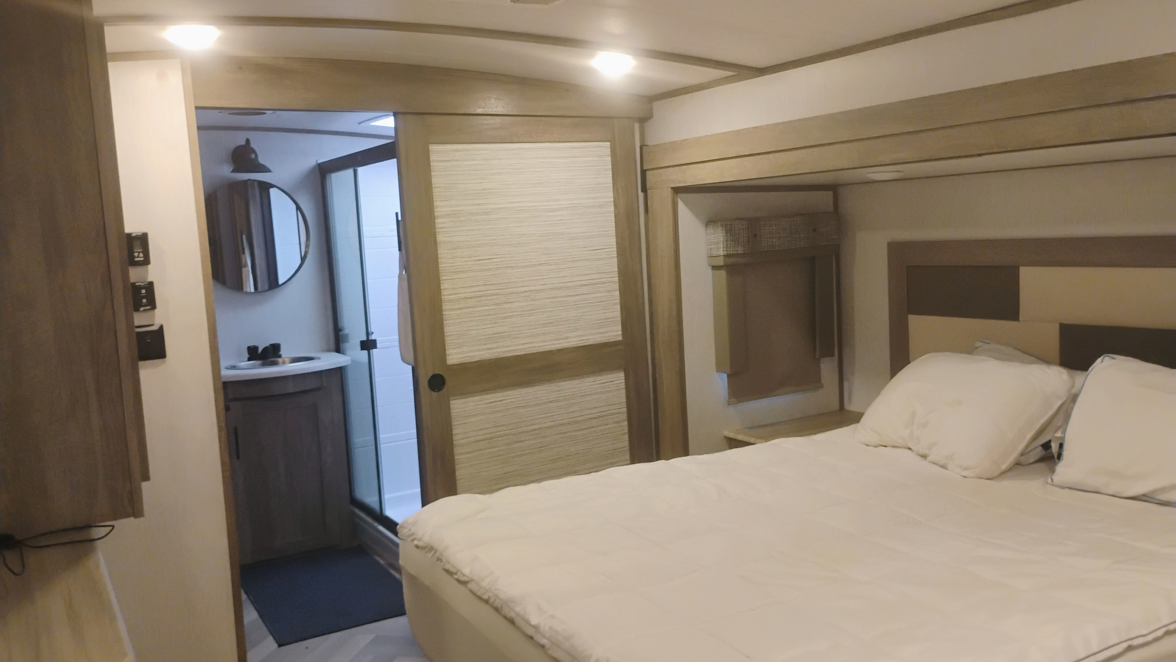 Modern RV rental features a comfortable bedroom and a convenient ensuite bathroom with a shower.. Forest River Salem Hemisphere Elite 2022