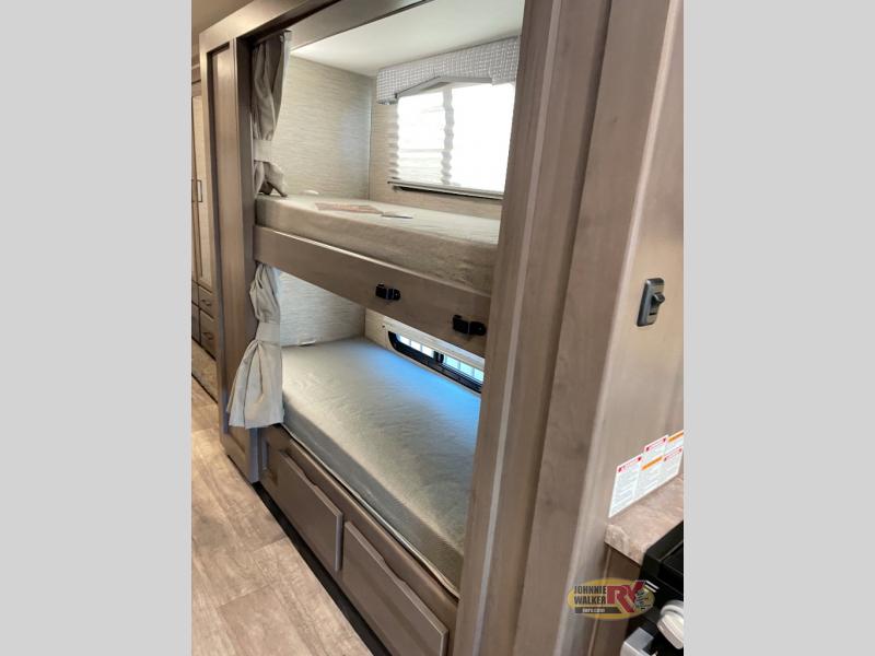 RV rental: Interior with cozy bunk beds and privacy curtains, offering comfortable sleeping for mobile living.. Thor Chateau 2023