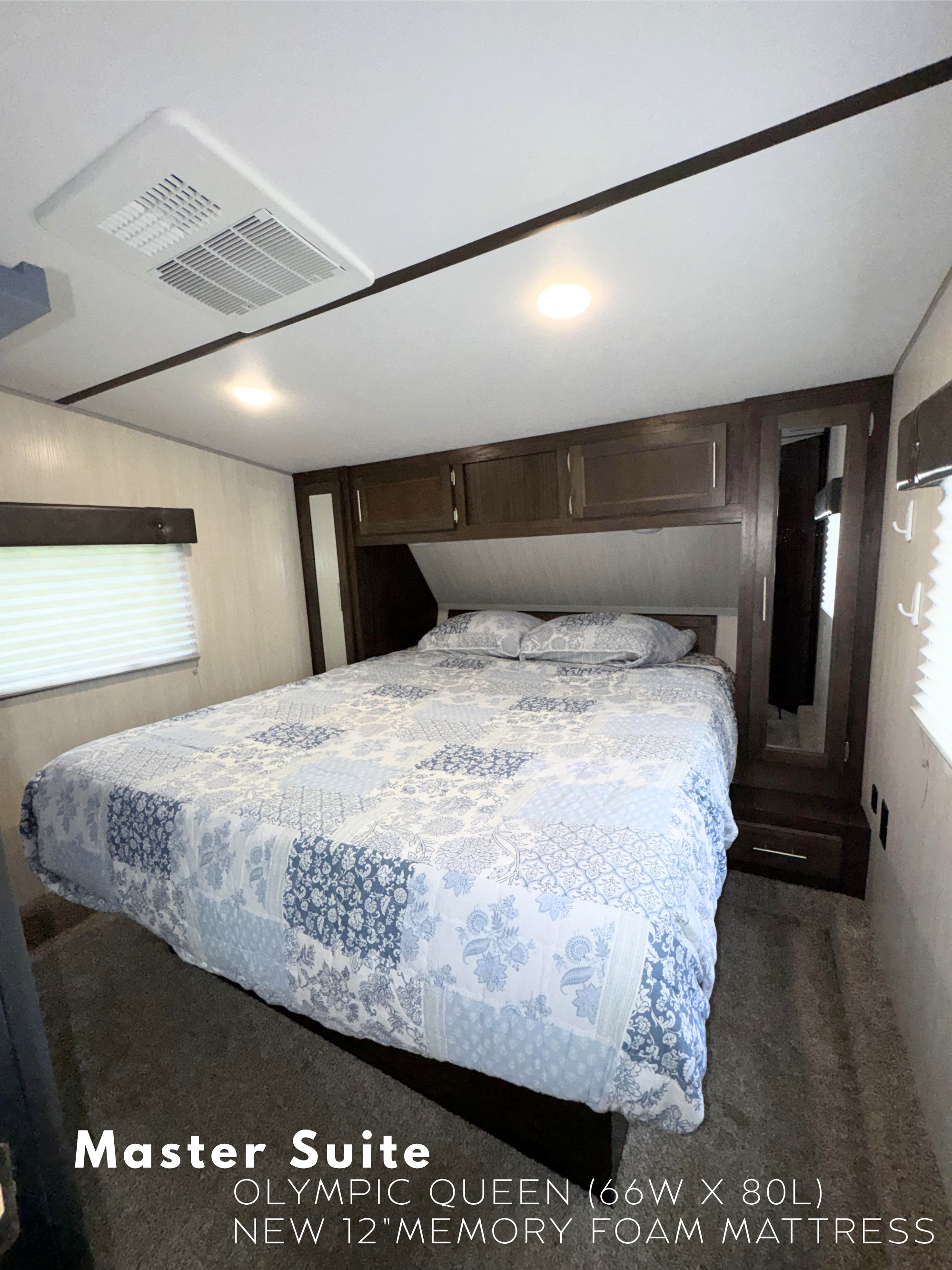 RV rental master bedroom: Olympic Queen bed with new 12" memory foam mattress and overhead storage.. Forest River Cherokee Wolf Pack Toy Hauler 2021