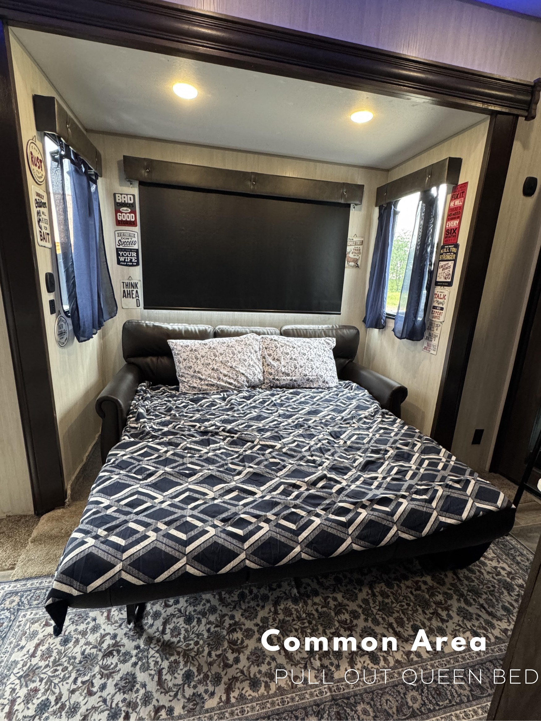 RV rental's common area features a comfortable pull-out queen bed, ready for guests.. Forest River Cherokee Wolf Pack Toy Hauler 2021