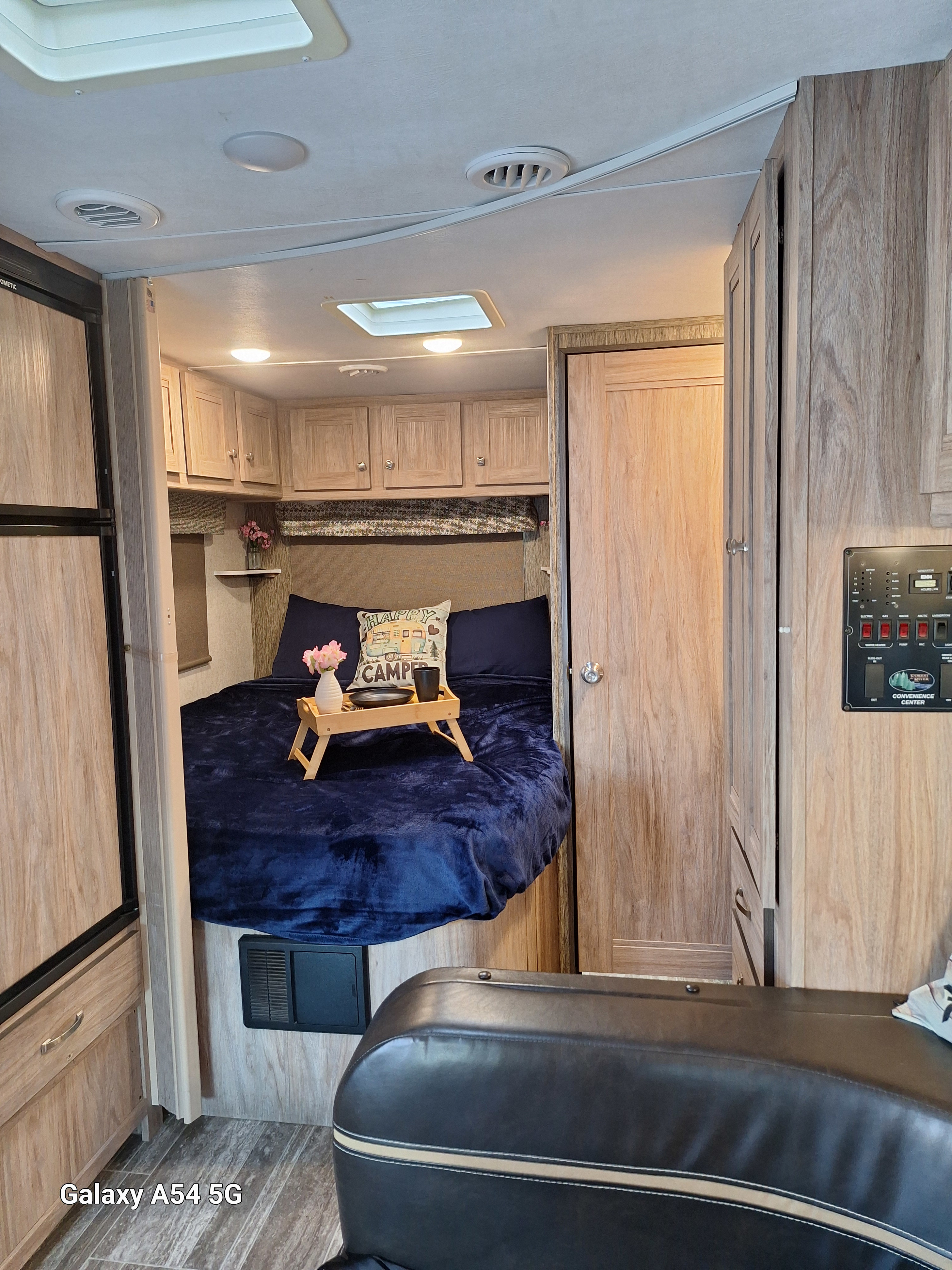Cozy RV interior bedroom perfect for your next rv rental adventure, featuring a bed, storage, and controls.. Forest River Sunseeker LE 2018