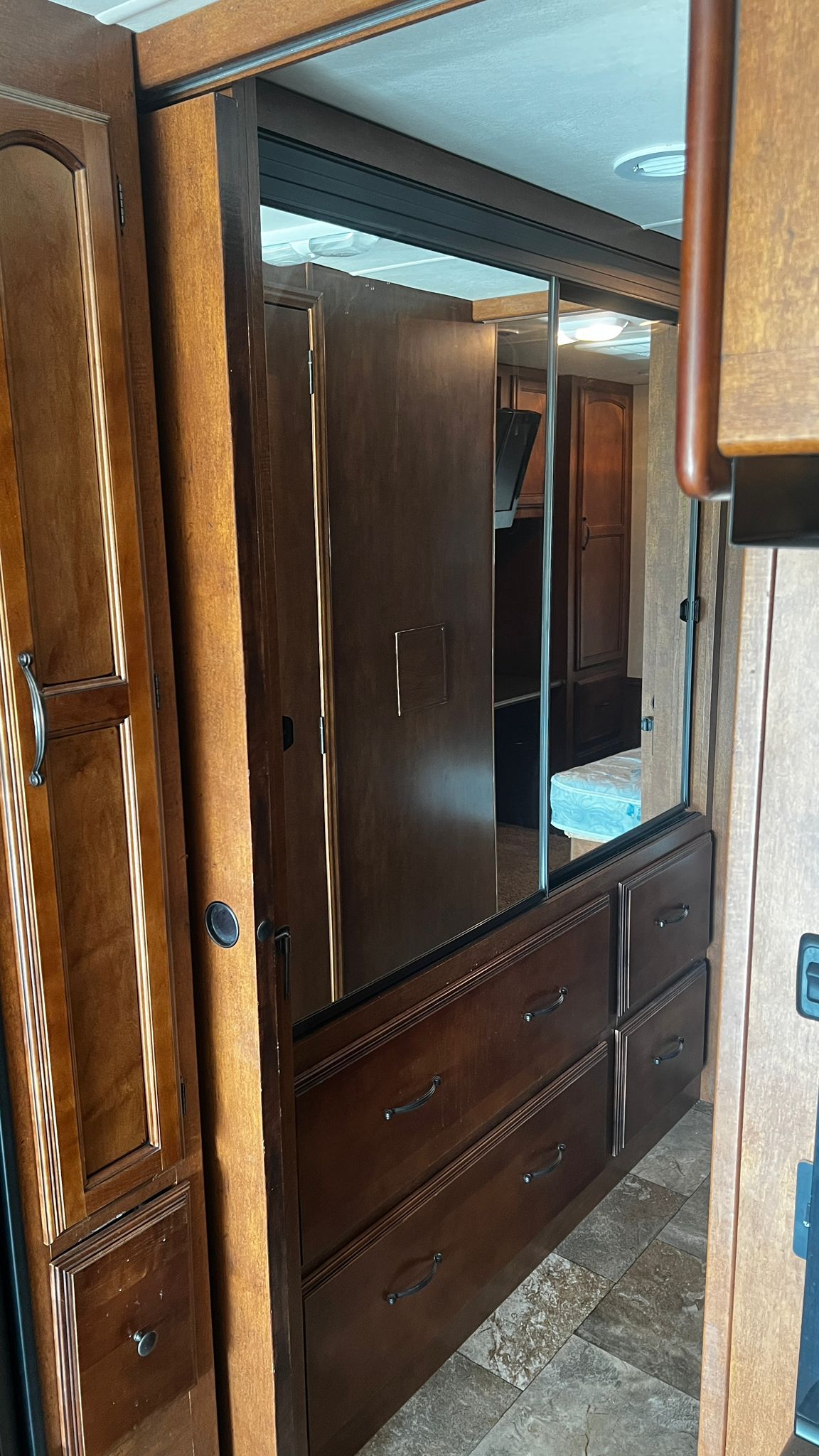 RV rental bedroom: Mirrored closet, drawers & wood cabinetry for ample storage.. Forest River Coachmen Mirada 2012