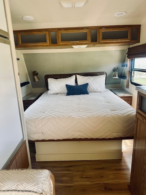 Comfortable RV rental bedroom with a cozy bed, stylish decor, and ample overhead storage.. Terry L Series 1995