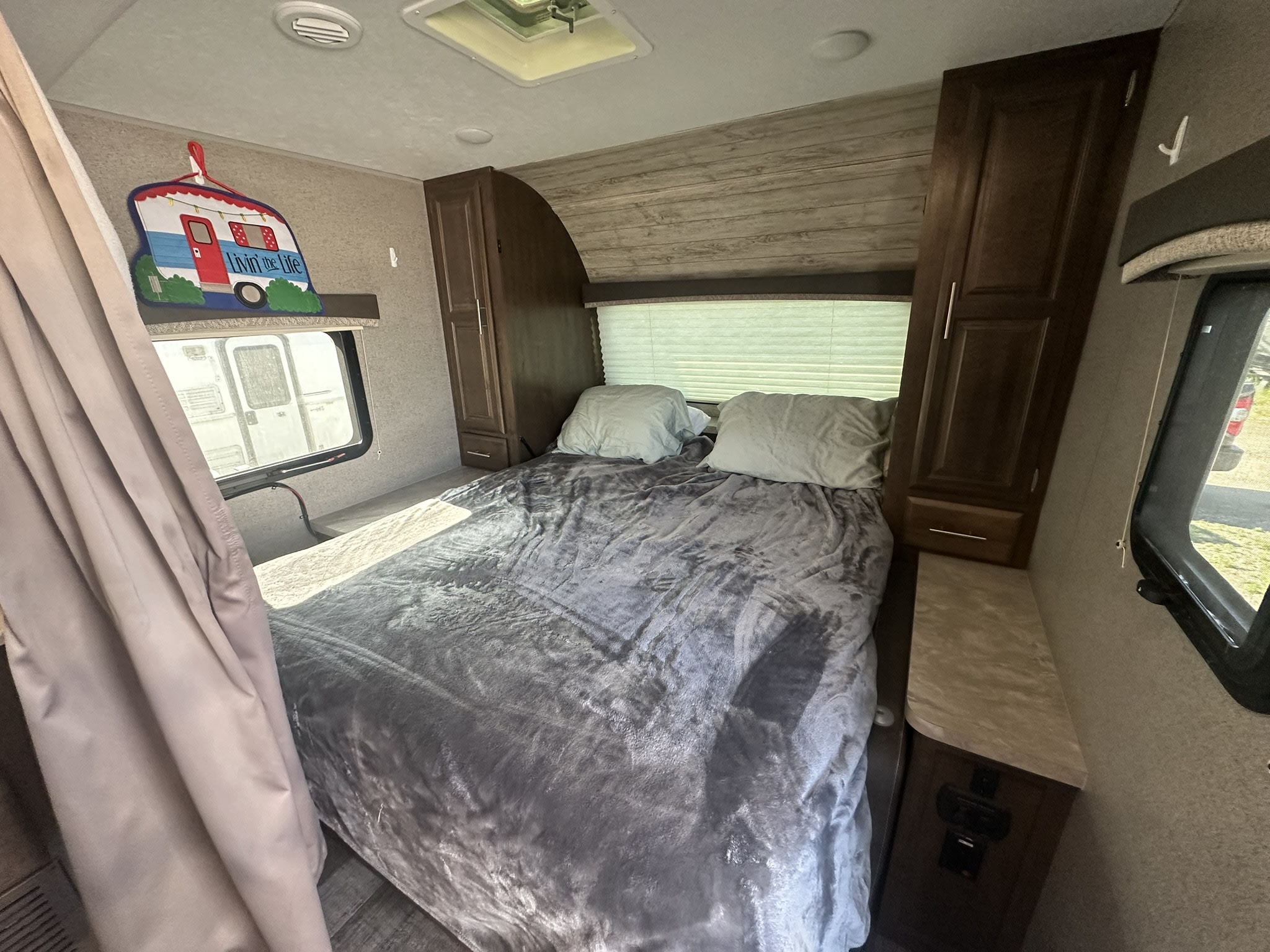 Cozy RV rental bedroom with storage, windows, and a comfy bed perfect for your travels.. Forest River Rockwood Mini Lite 2020