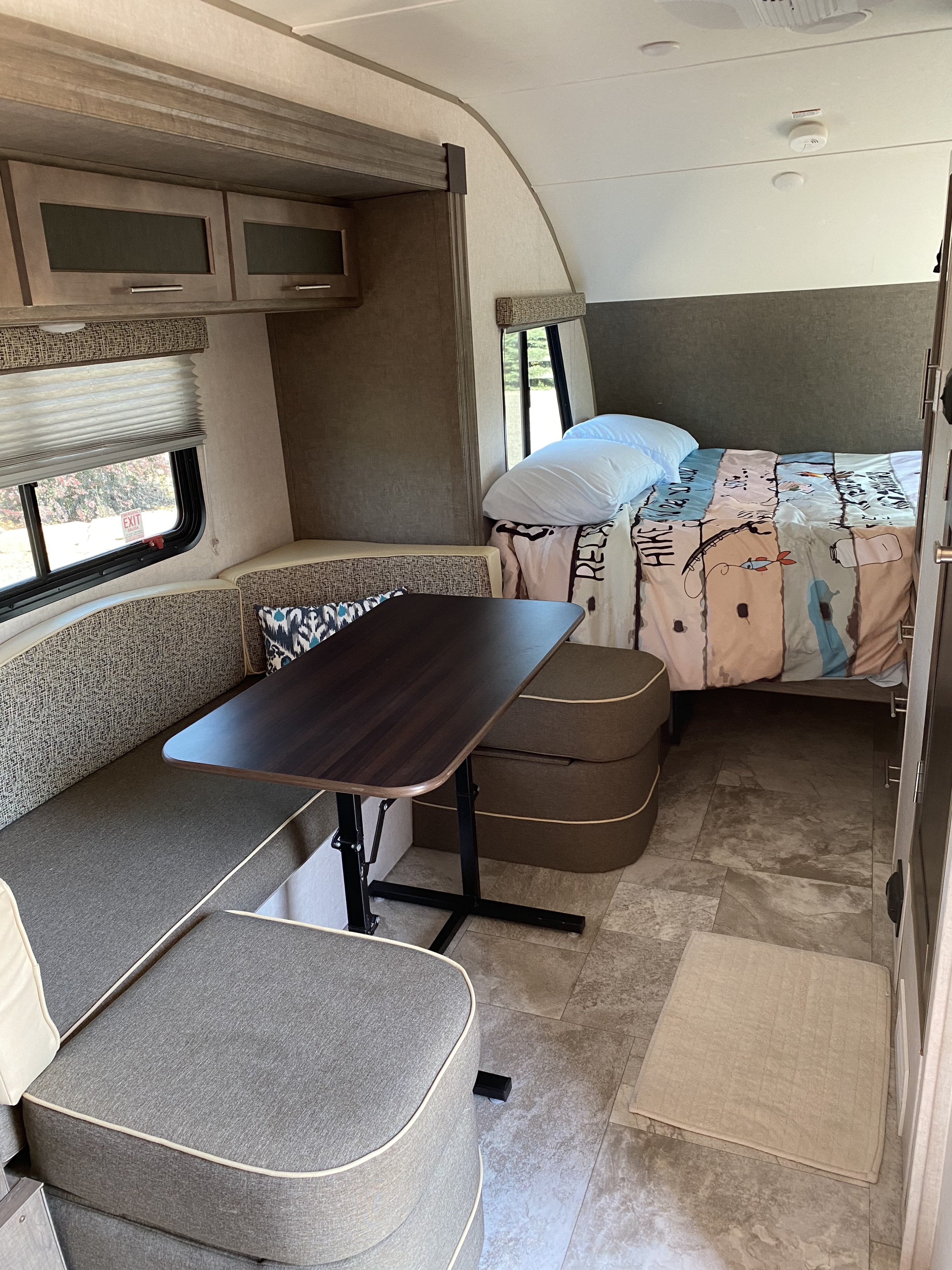 RV rental interior: cozy dinette area, comfortable bed, and storage cabinets. Ideal for a travel adventure.. R-Pod Hood River Edition 2018