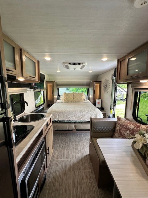 Step inside this spacious RV rental featuring a complete kitchen, comfortable bed, and inviting dining area for your next trip.. No Boundaries 19.3 2020