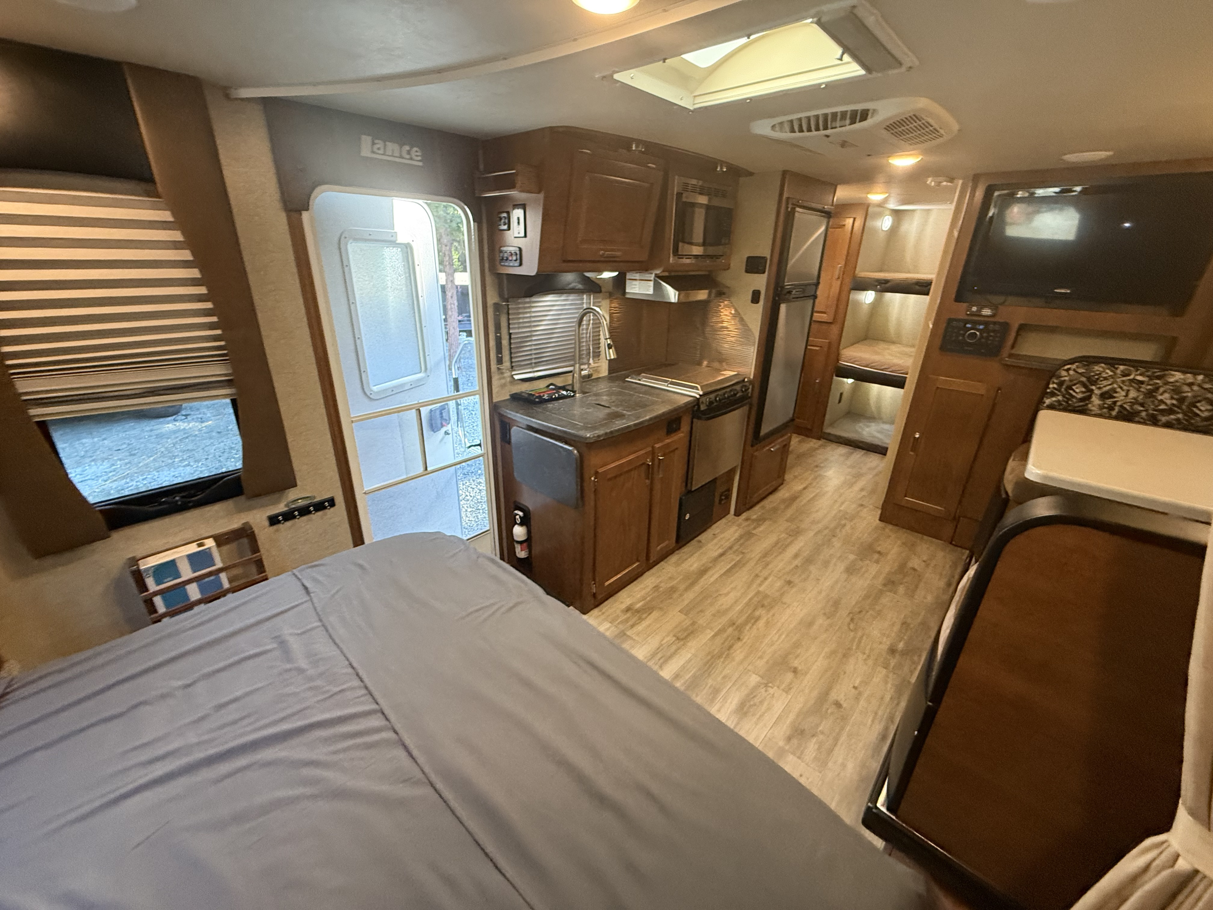 This RV rental offers a comfy main bed, bunk beds, full kitchen, TV, & spacious interior for your road adventures.. Lance Manufacturing Lance Manufacturing Trailer 2017