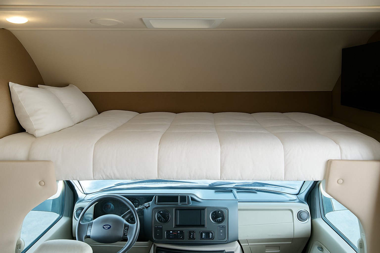 Overhead bed with white bedding & pillows in an RV rental, with a TV & driver's cab below.. Winnebago Outlook 2019