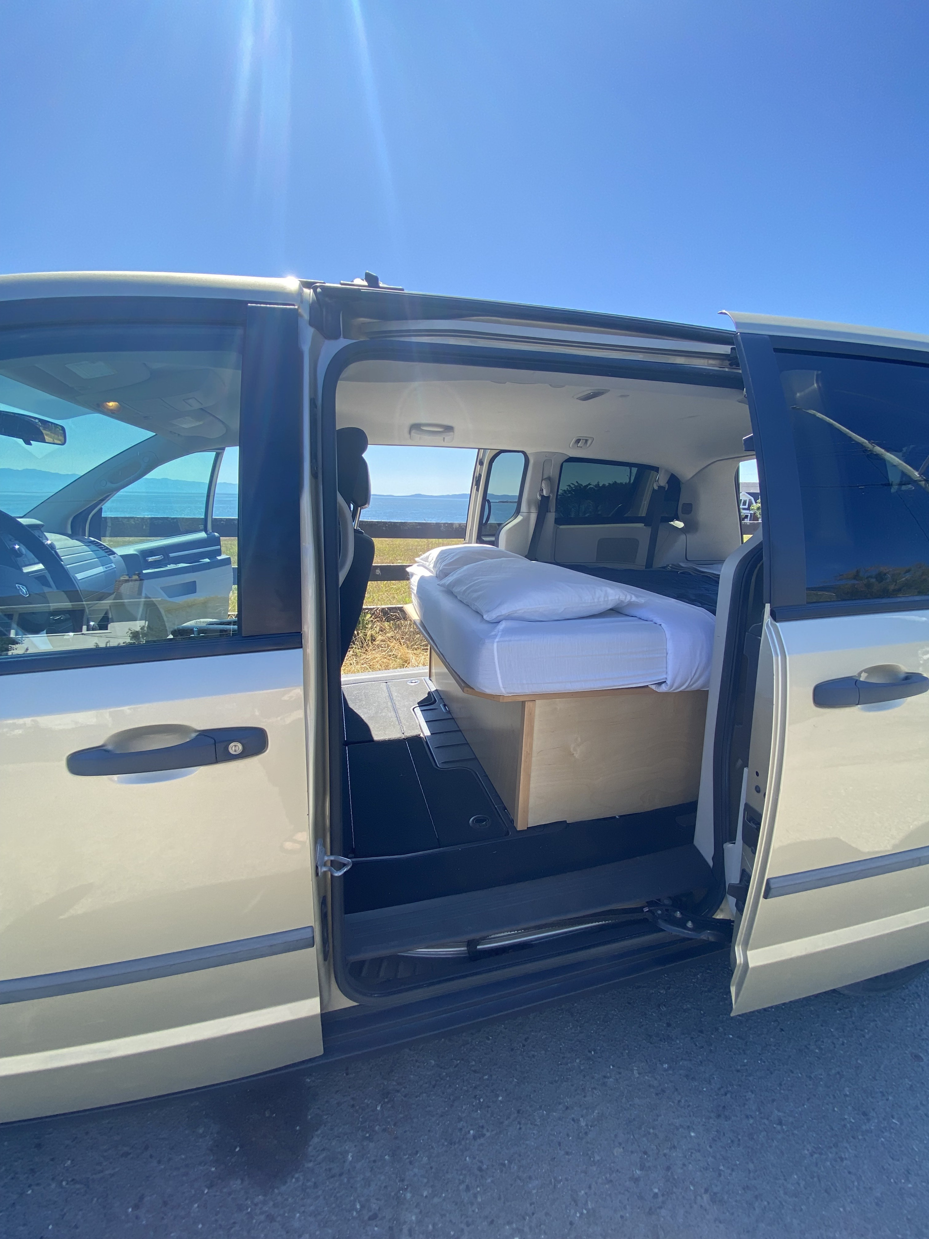 RV rental: Minivan camper with a comfortable bed, open to a beautiful ocean view. Perfect compact travel for any adventure.. Dodge Grand Caravan SE 2010