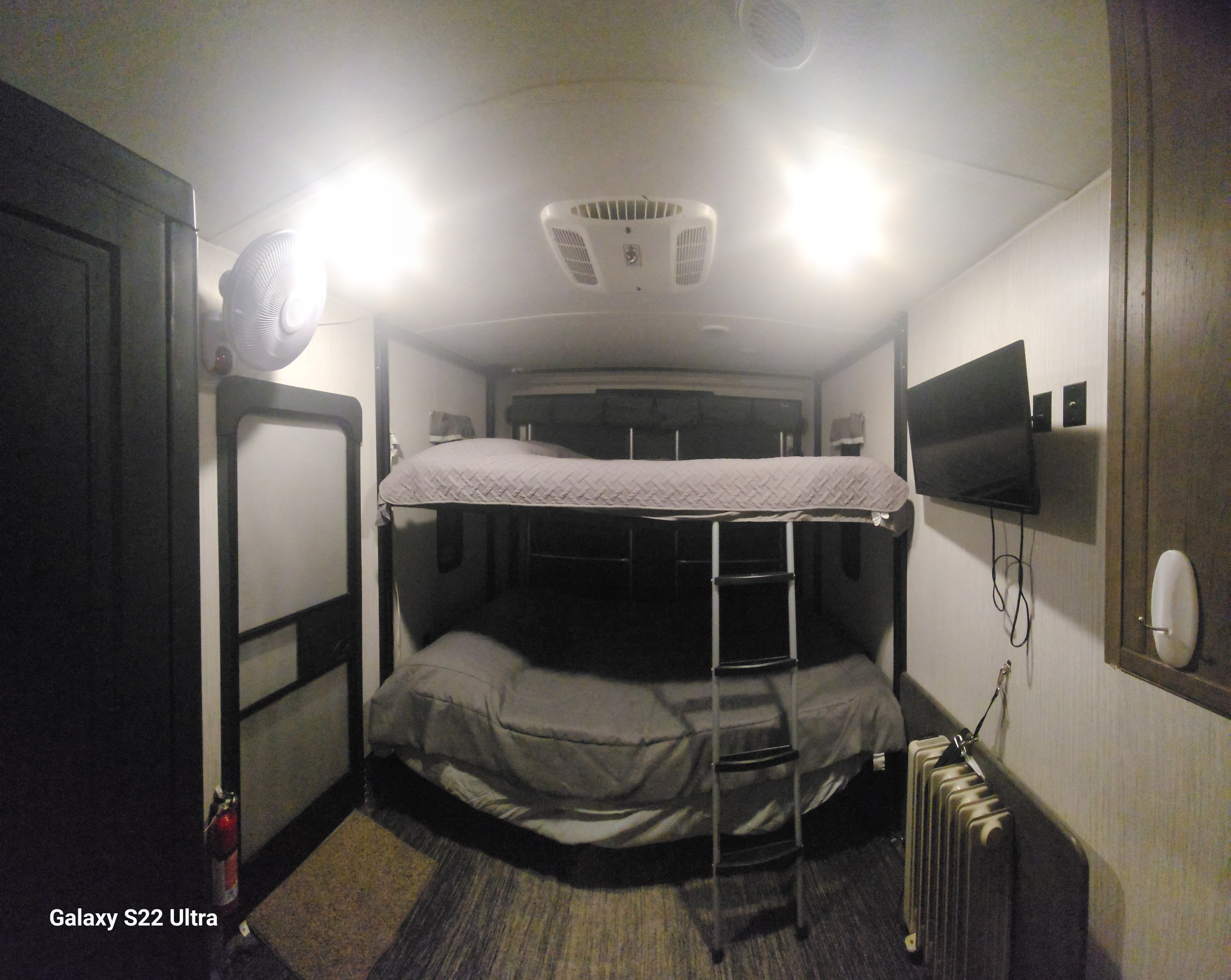 Cozy RV rental interior with double bunk beds, a TV, AC, and a heater, ready for your travels.. Forest River Puma 2021
