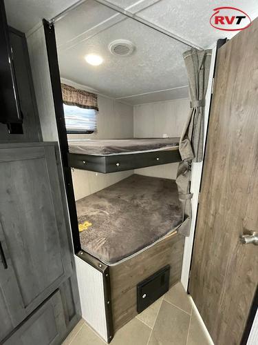 This RV rental offers a compact sleeping area with two comfy bunk beds, a window, and amenities for mobile living.. Forest River Palomino Puma XLE 2020