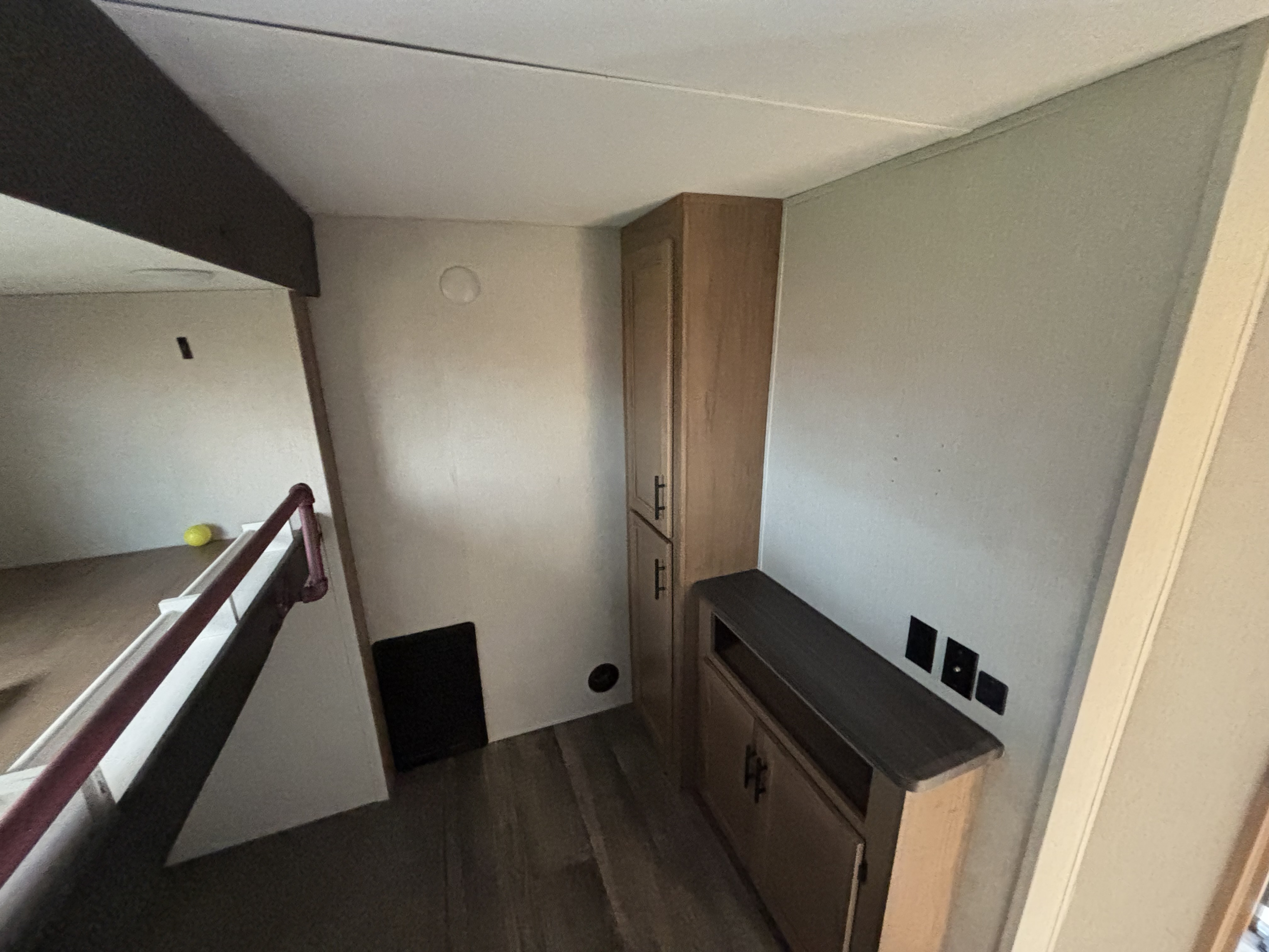 This RV rental's interior features a functional bunk bed loft, tall storage cabinets, and essential living space.. Forest River Cherokee Arctic Wolf 2023