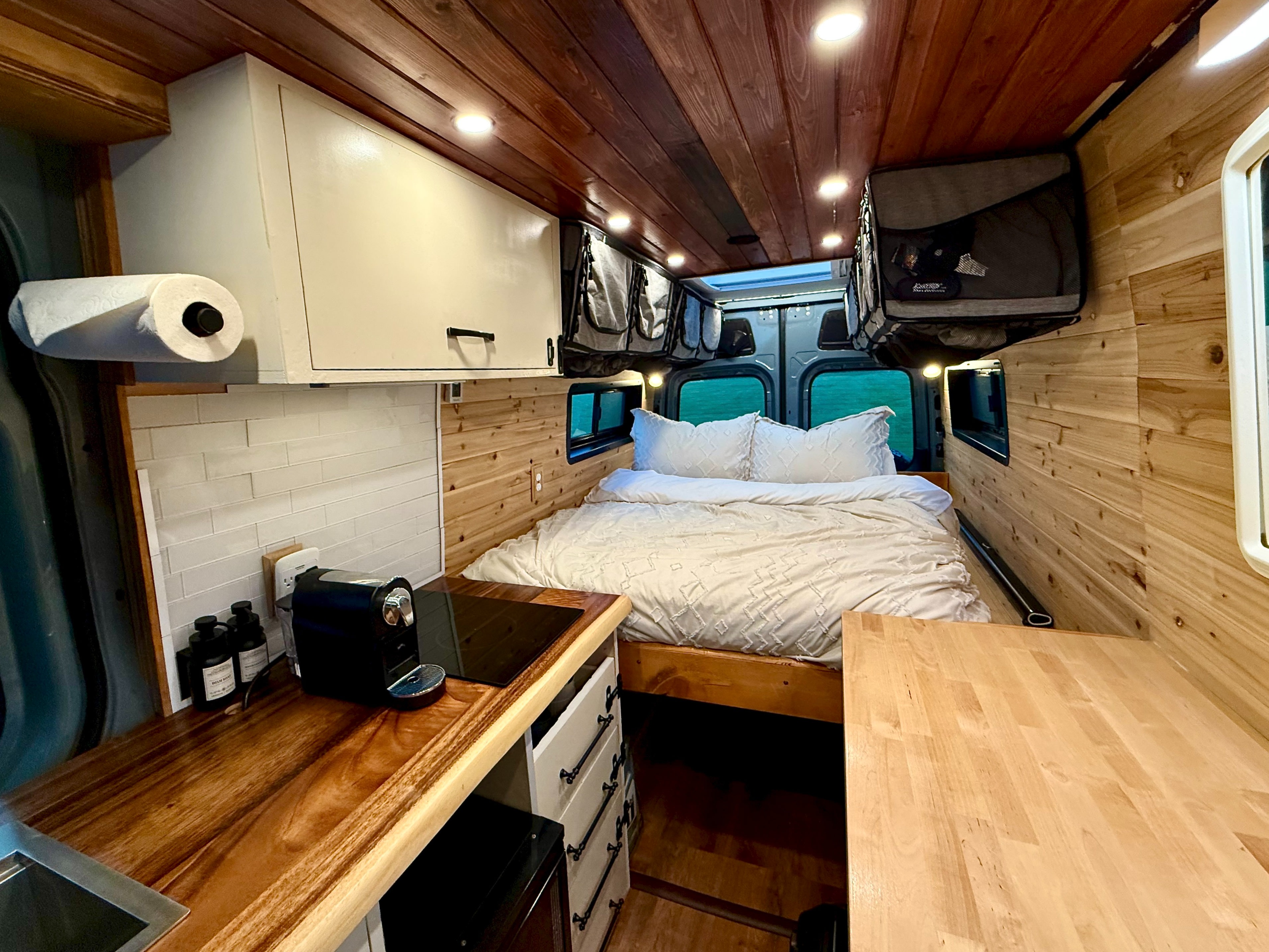 Explore this charming rv rental! A custom van interior with a bed, kitchen, and overhead storage for comfy travel.. MERCEDES-BENZ SPRINTER 2500 170 WB 2022