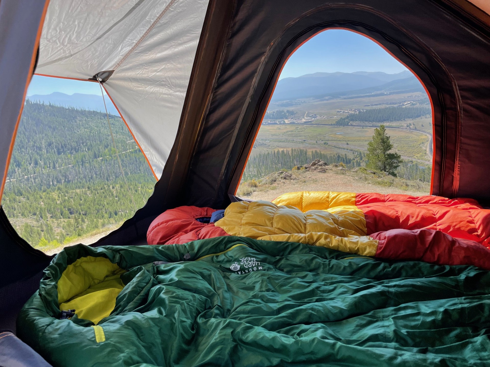 Inside a cozy **rv rental**, sleeping bags offer comfort with panoramic mountain and valley views. Ideal for a scenic outdoor adventure.. Peak Toyota 4Runner TRD Pro 2016